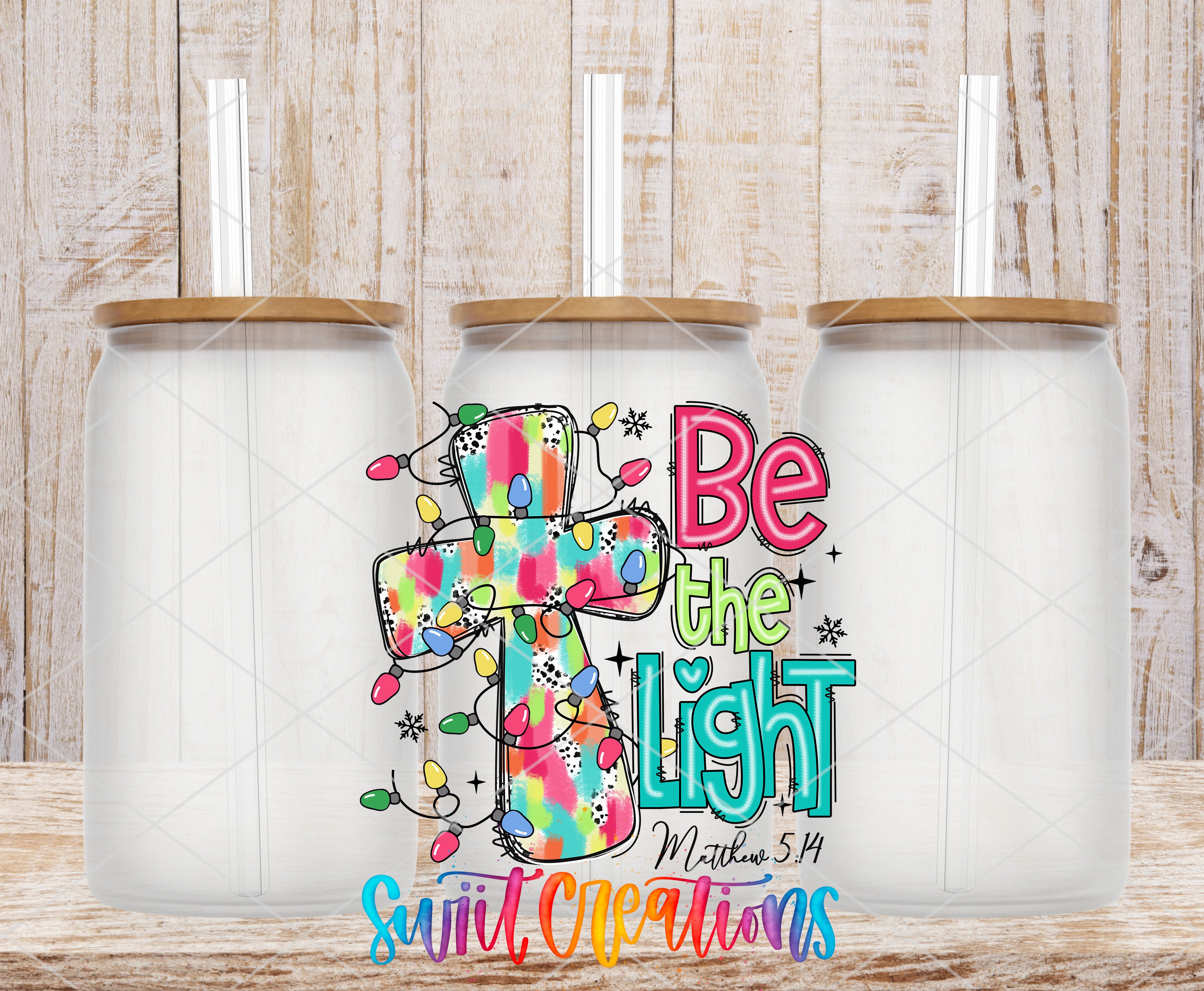 three clear glass jars with lids, each containing a straw. The jars are arranged in a row, and there is a colorful graphic design on the front of the jars that includes a cross and the text "Be the light" along with a Bible verse reference.