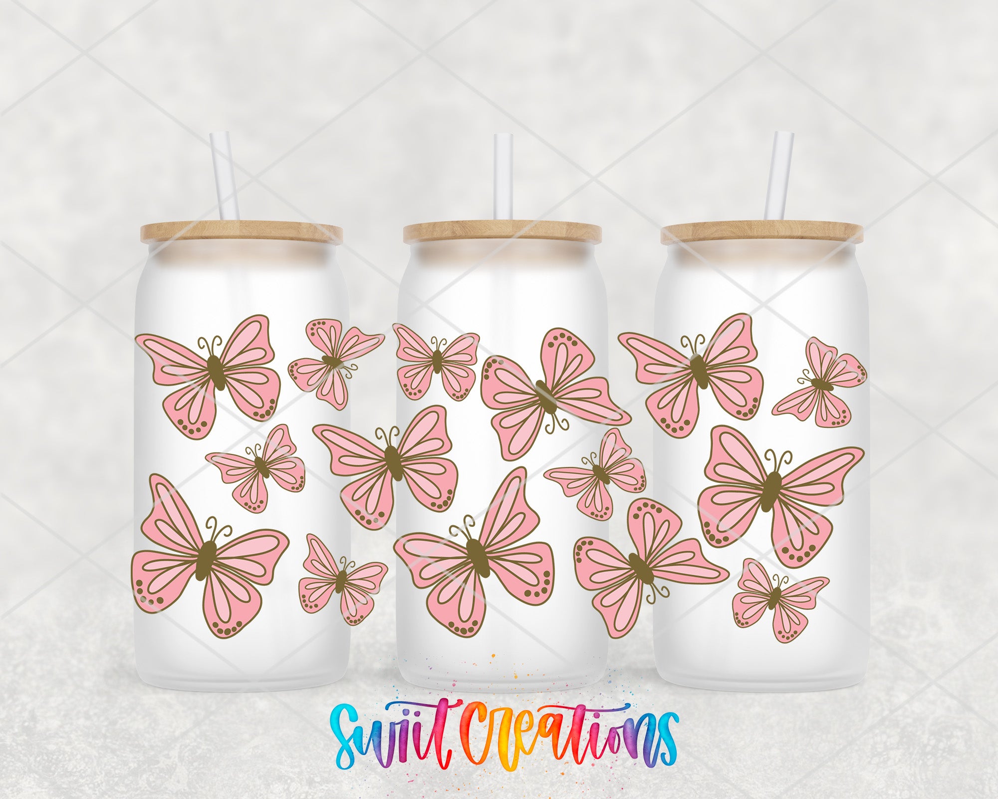 Three frosted glass tumblers with pink butterflies printed on them, arranged in a row.