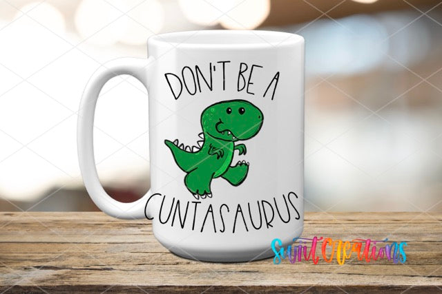 a white coffee mug with a green dinosaur on it