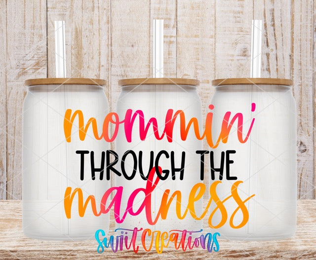two coffee mugs with the words mommy through the madness on them
