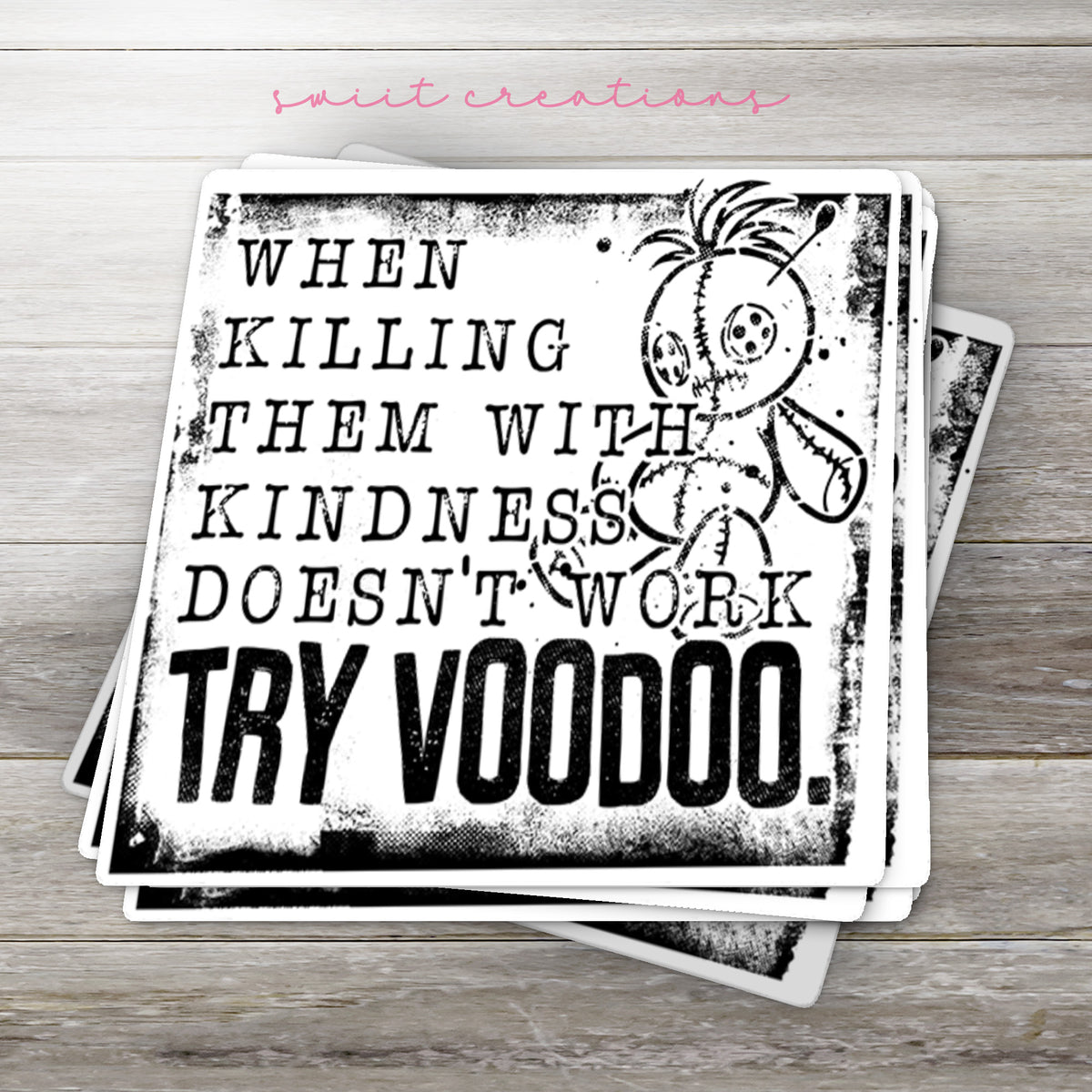 Stack of Try Voodoo glossy stickers on a gray wood table