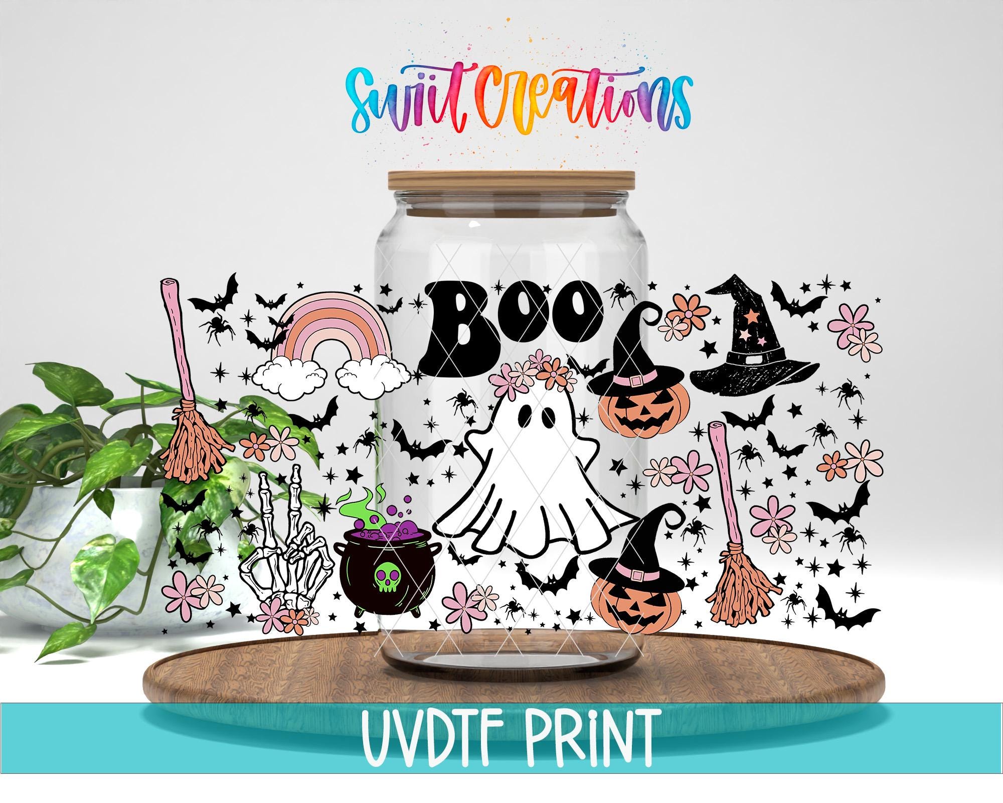 a jar filled with halloween decorations on top of a table