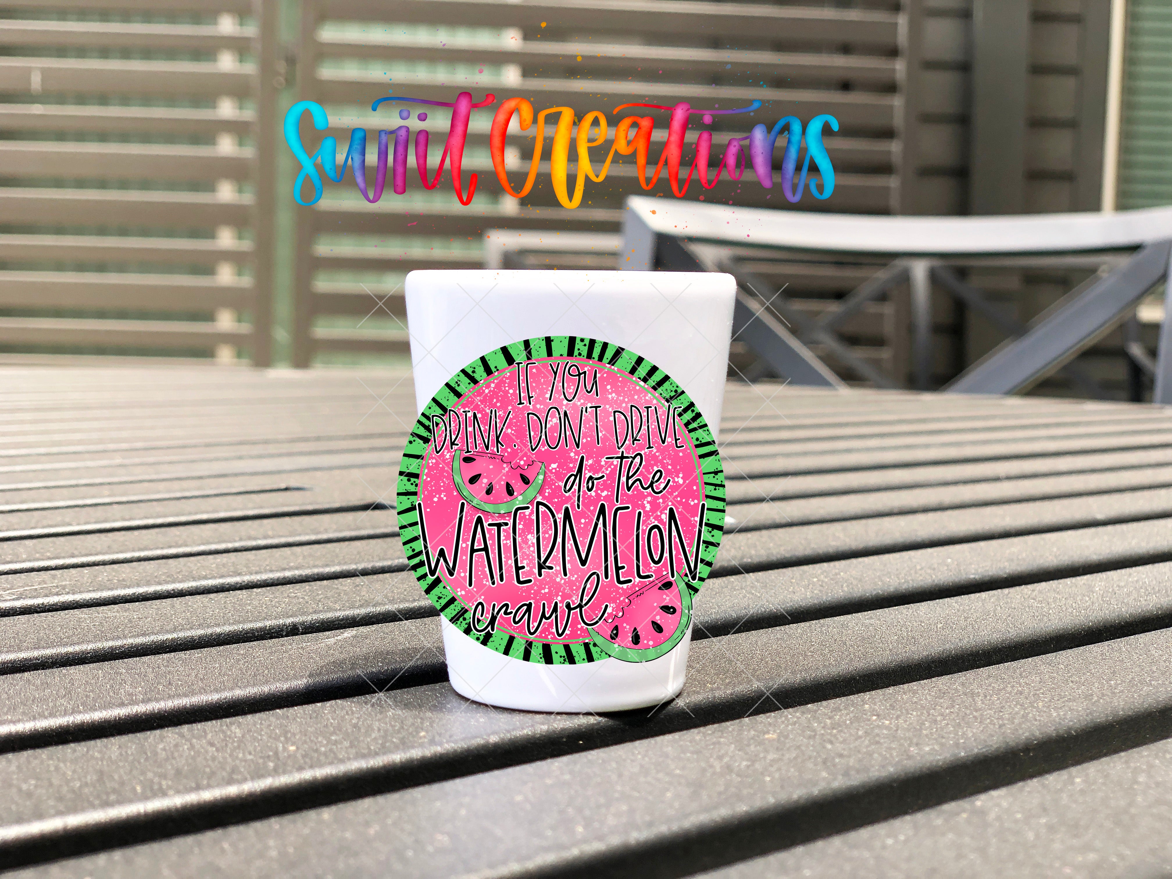a cup of watermelon sitting on a bench