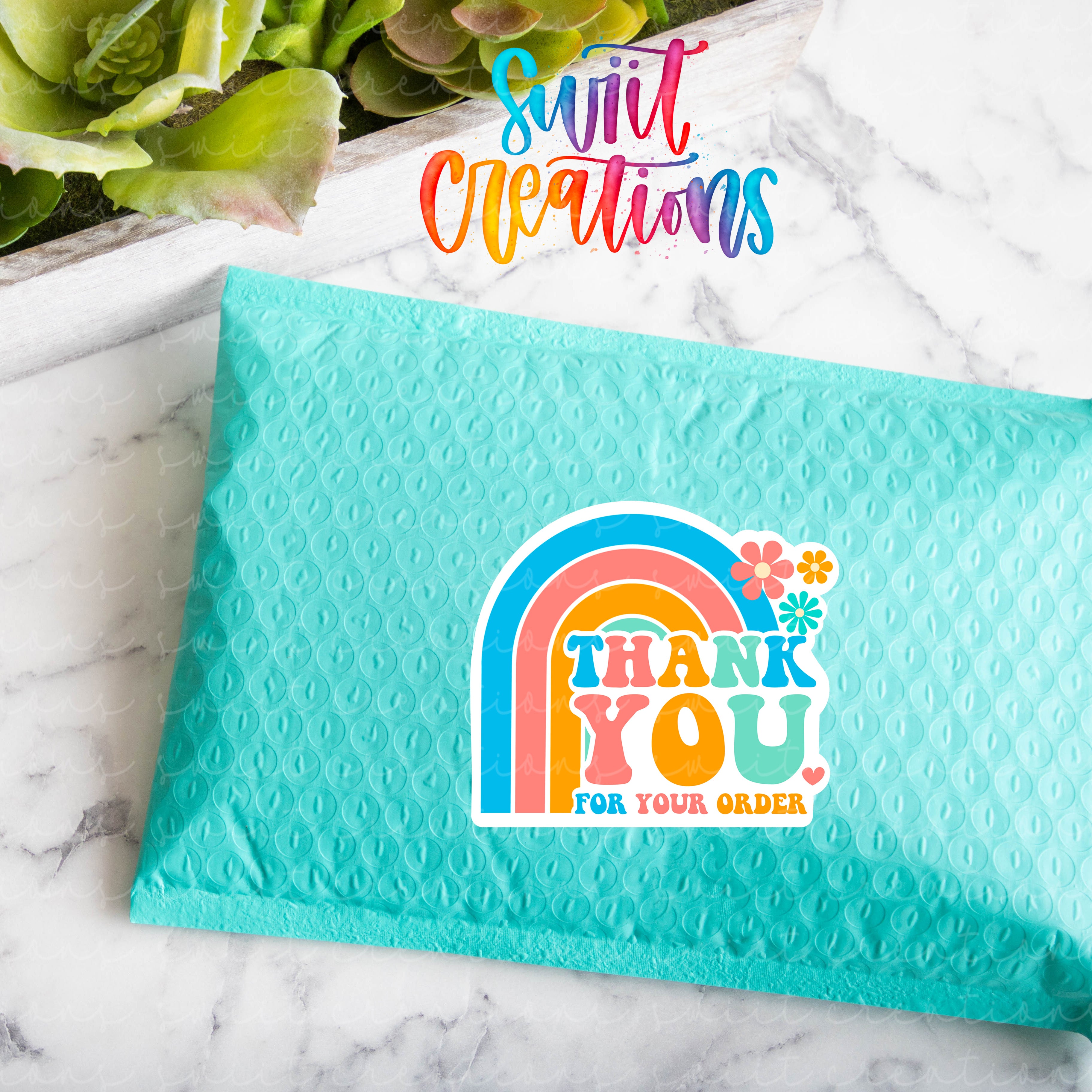 a green bag with a thank you sticker on it