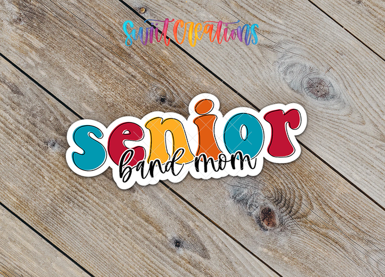 a sticker with the text "senior band mom" written on it, placed on a wooden surface.