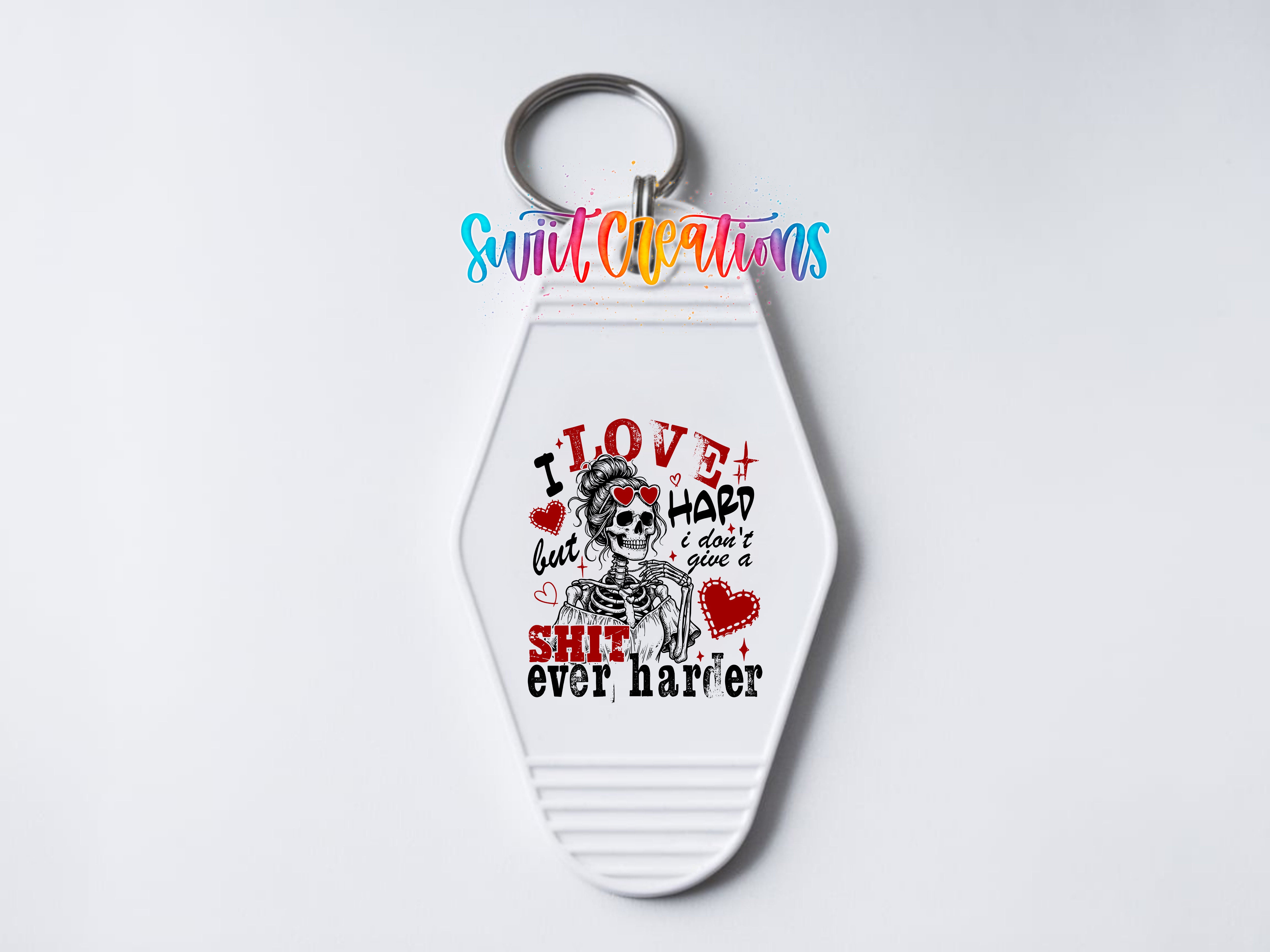 A keychain with a white keyring and a printed design on it. The design features a skeleton with the text "I LOVE HARD I DON'T HARD SHIT EVER HARPER" written around it.