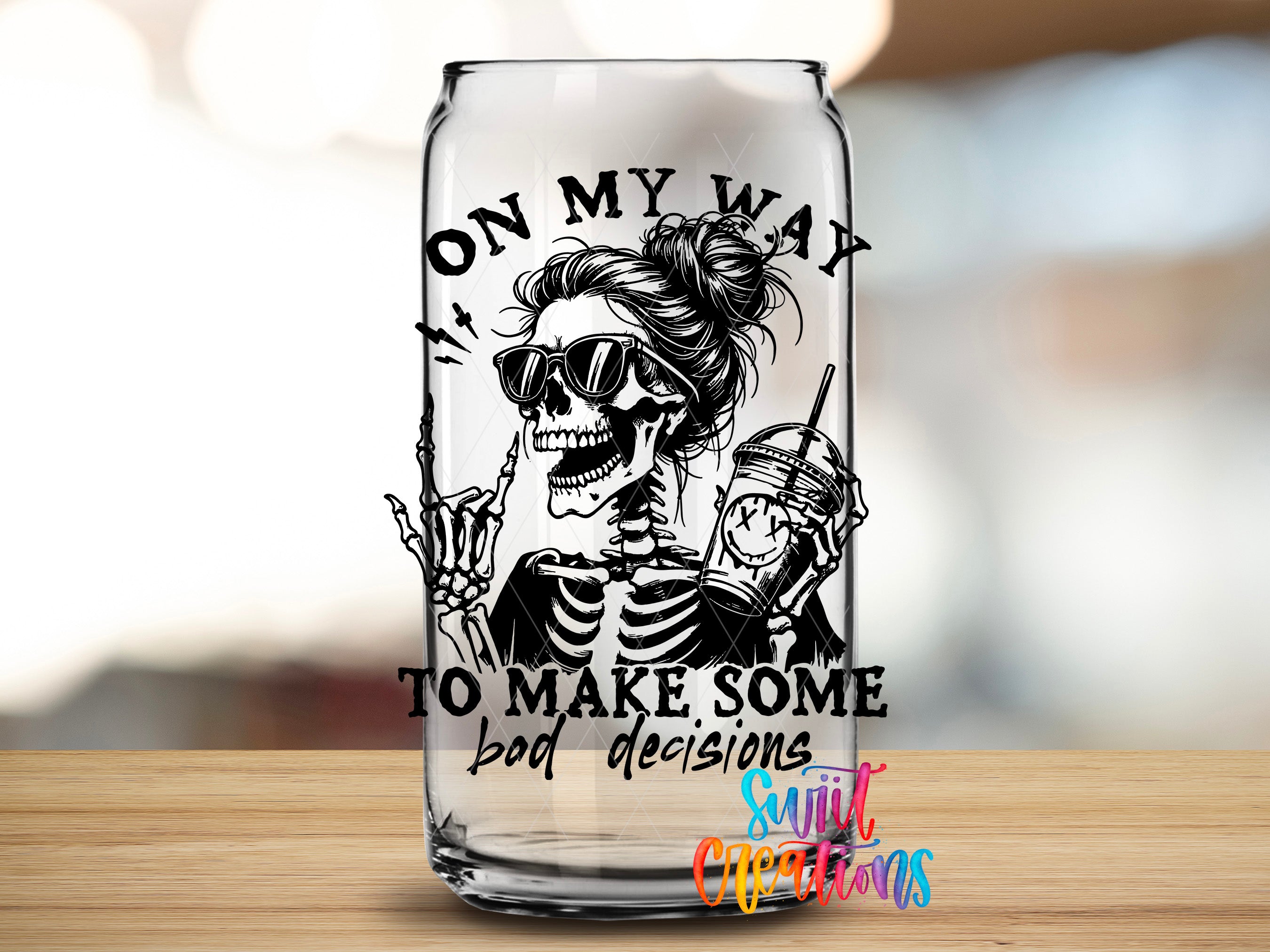 A glass can with a skeleton wearing sunglasses and holding a drink, along with the text "ON MY WAY TO MAKE SOME BAD DECISIONS" printed on it.