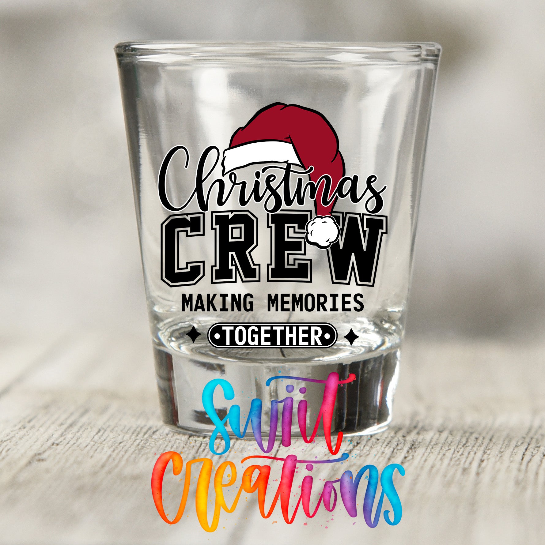 A shot glass with a Christmas crew design and the text "Christmas Crew Making memories together" printed on it.