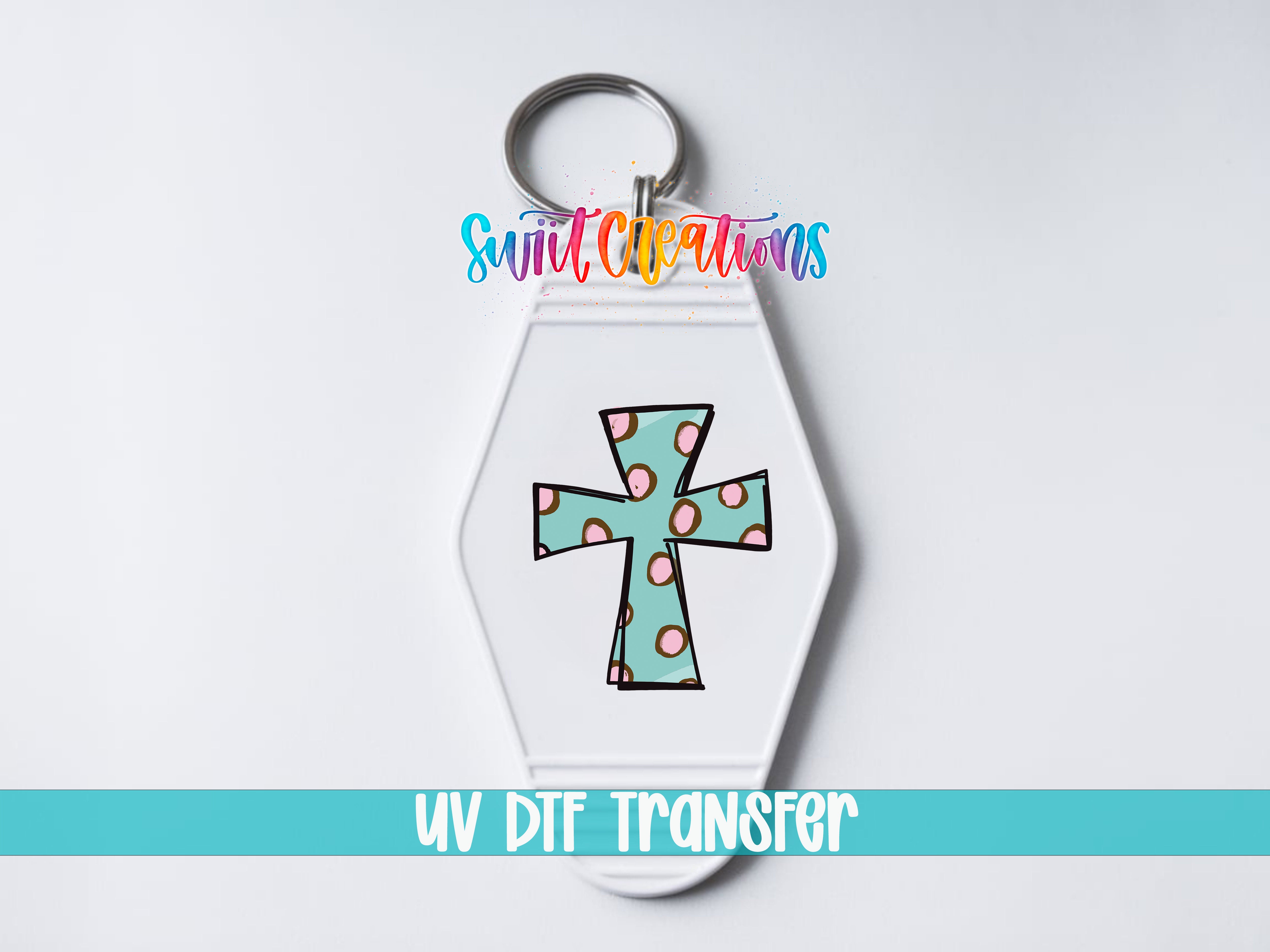A keychain with a colorful polka dot cross design and the text "UV DDF Transfer" printed on it.