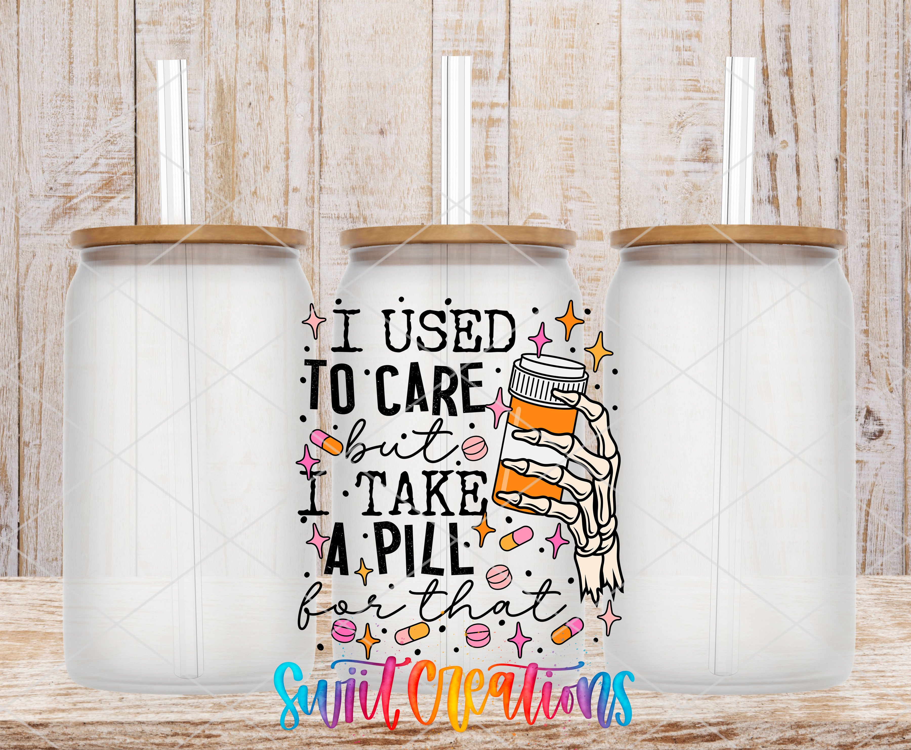 three clear glass jars with lids, each containing a straw. The jars are arranged in a row, and there is a colorful graphic design on the front of the jars that includes text and illustrations.