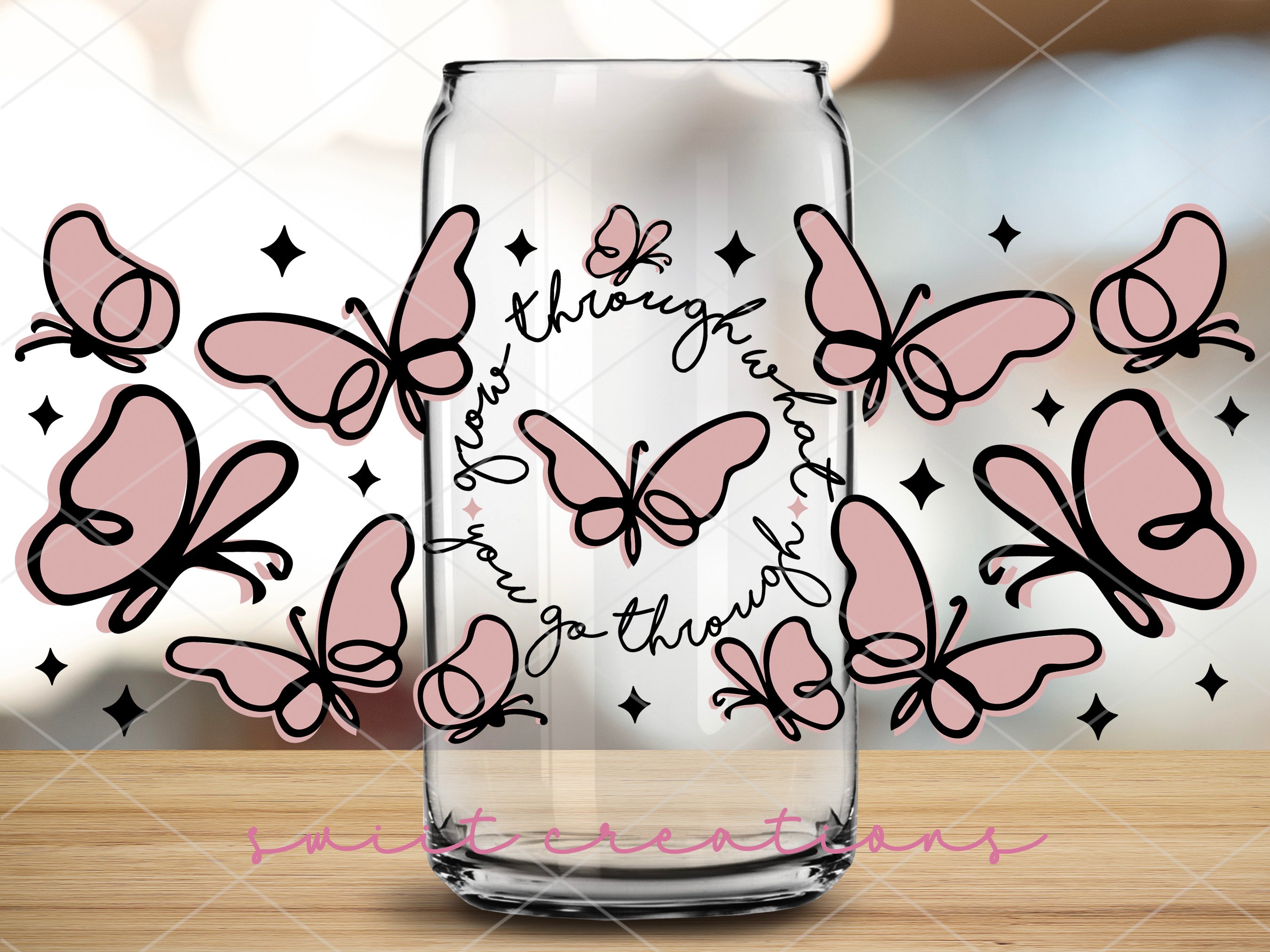 a glass with some pink butterflies on it