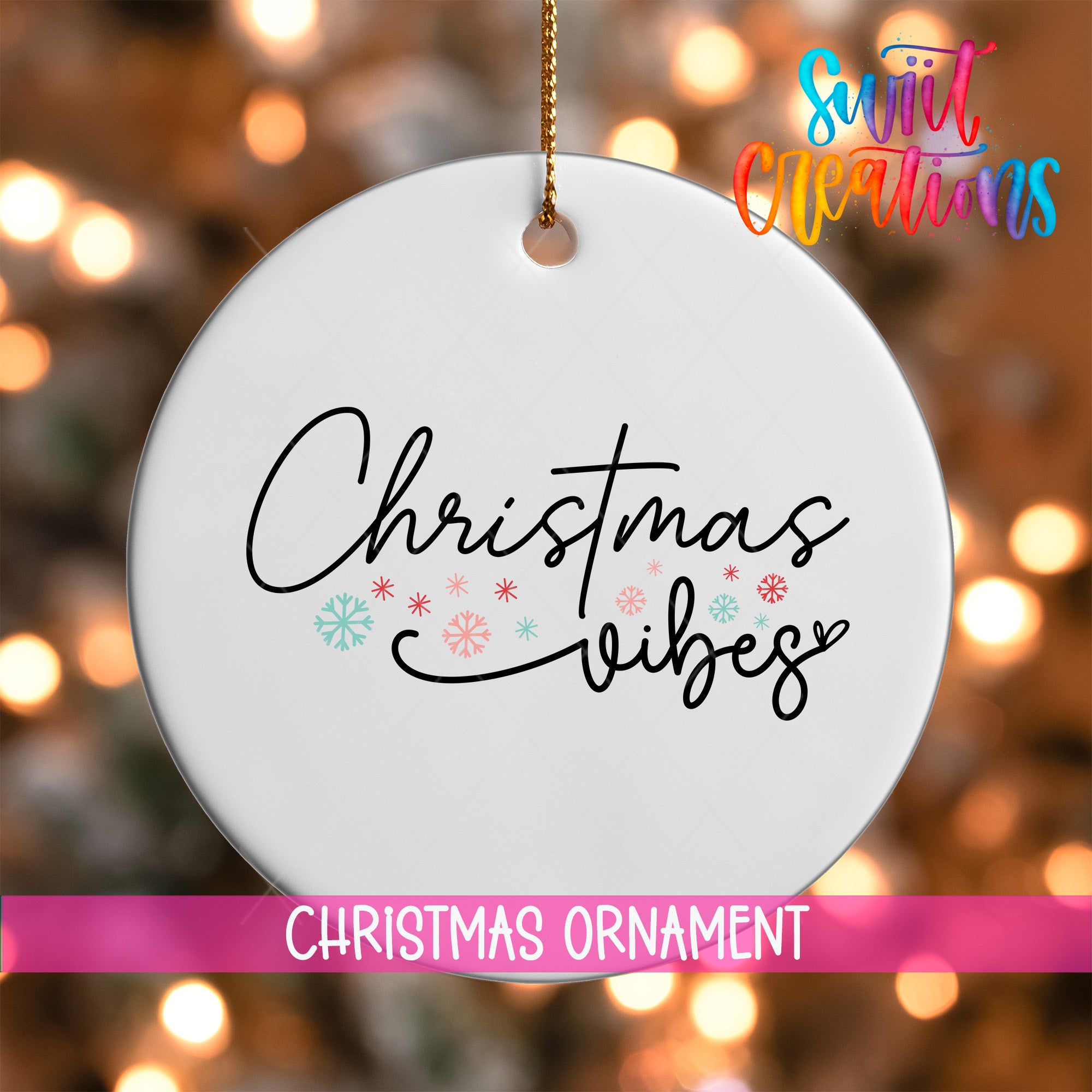 A white Christmas ornament with the text "Christmas vibes" written on it, hanging against a background of colorful lights.