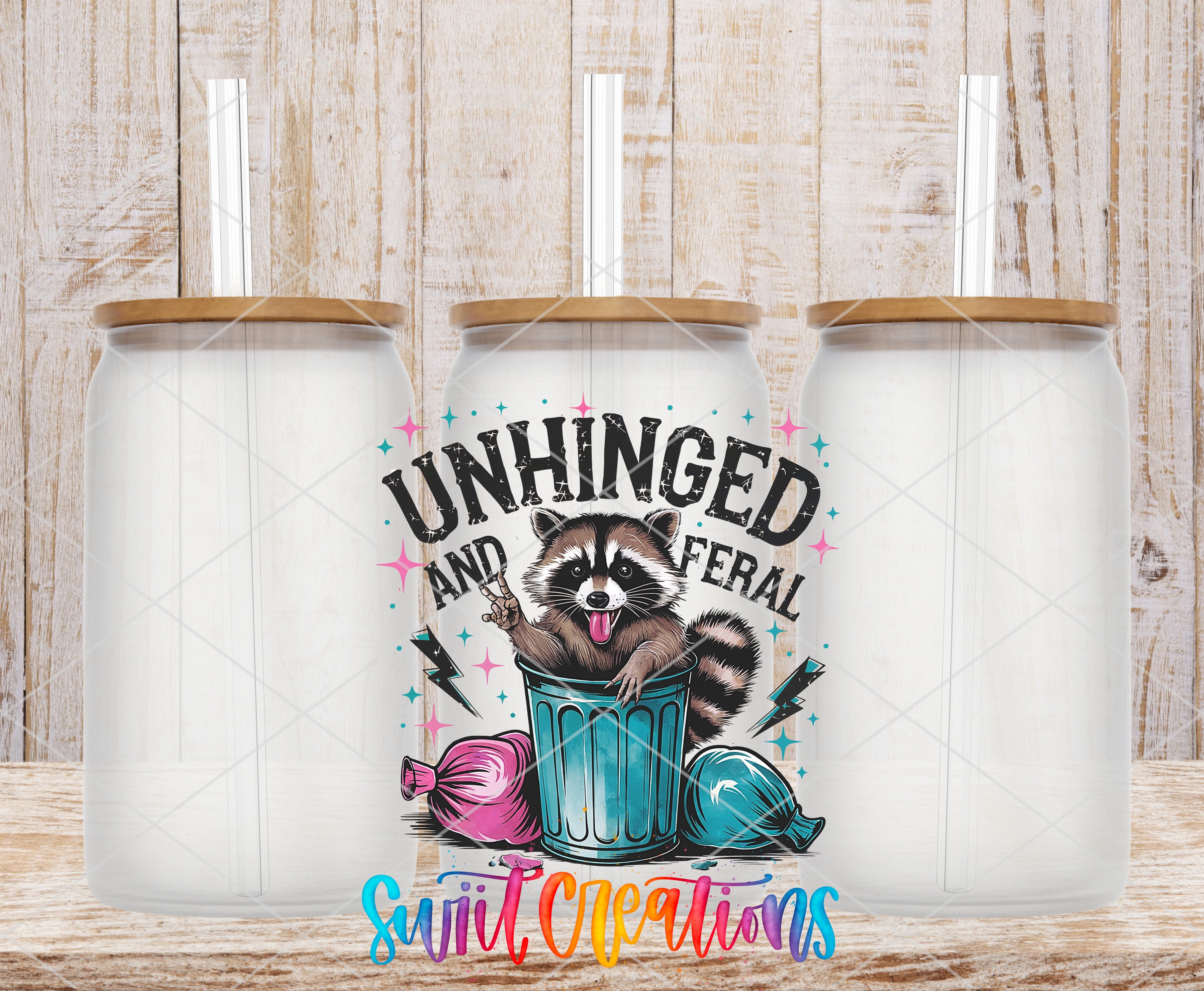 a colorful and whimsical design of a raccoon sitting in a trash can, surrounded by various objects such as a pink bag and a blue bag. The text "UNHINGED AND FERAL" is prominently displayed, along with the text "Swift Creations" at the bottom of the image.