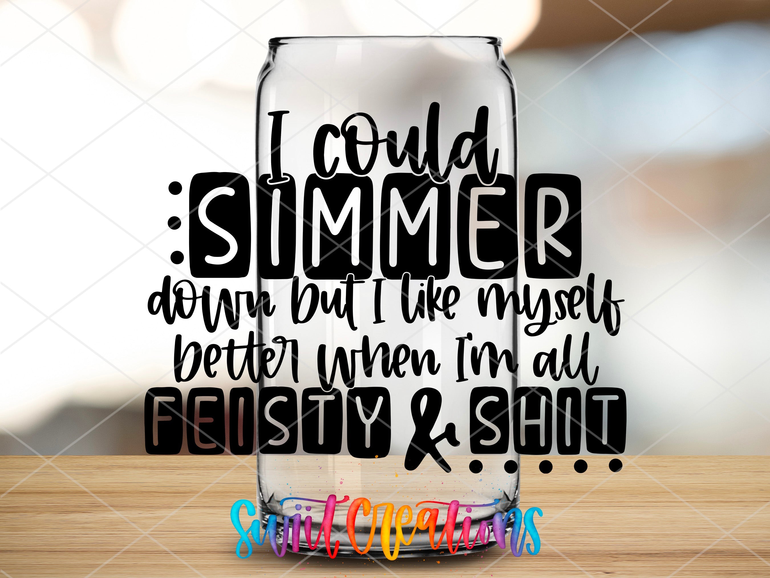 a glass with a quote on it sitting on a table