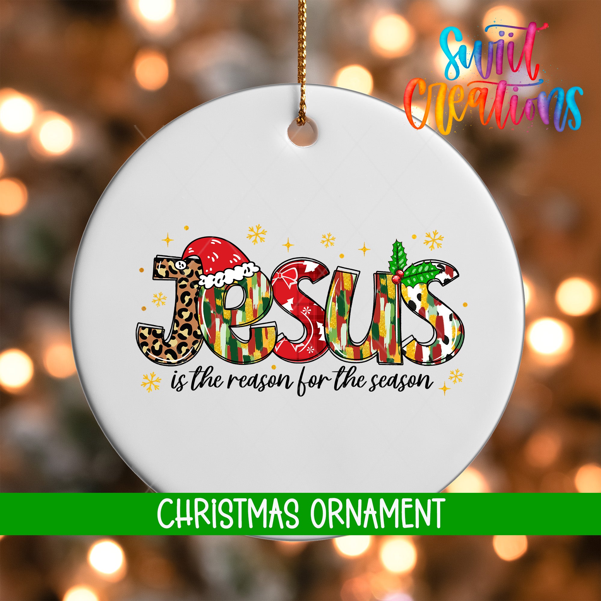 A white Christmas ornament with the word "JESUS" written in a colorful, stylized font.