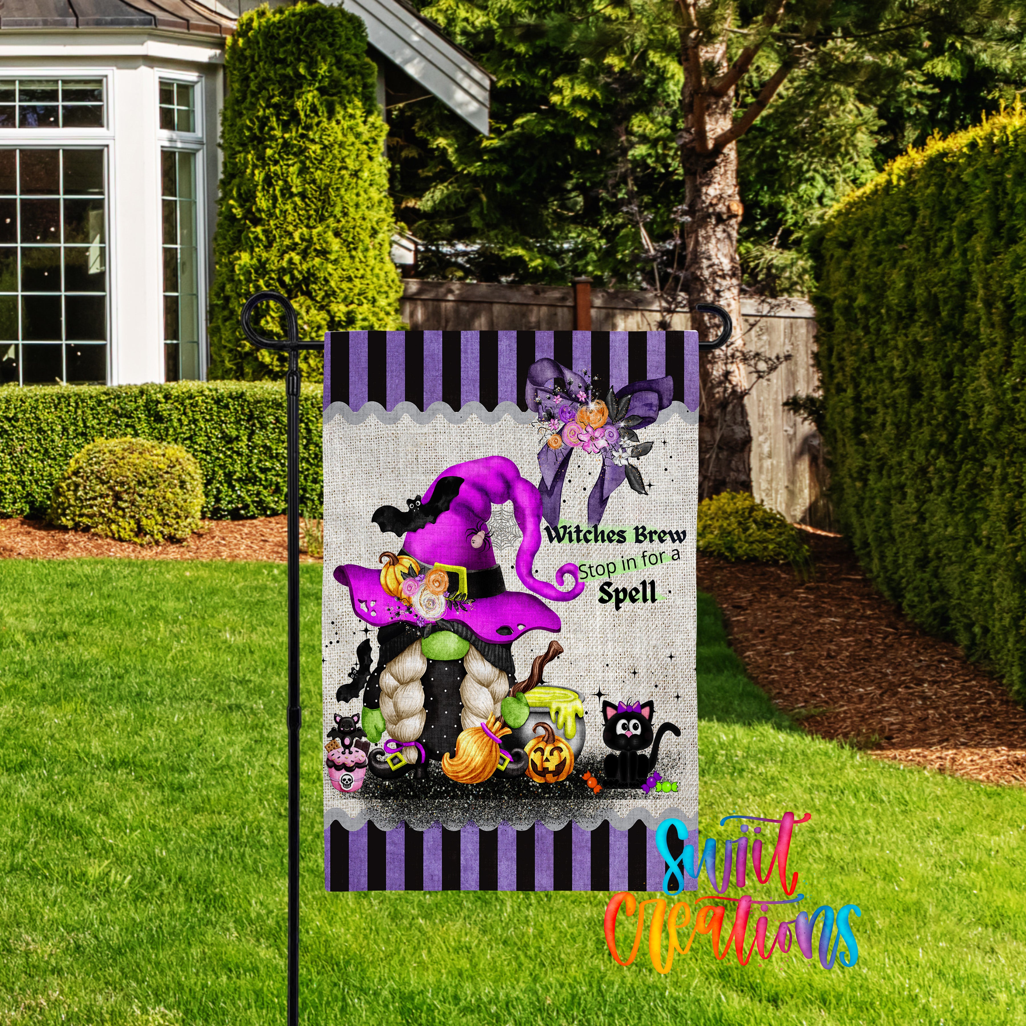 A Halloween-themed garden sign featuring a purple witch, a gnome, and various Halloween-related elements, such as pumpkins and bats, is displayed in a yard.