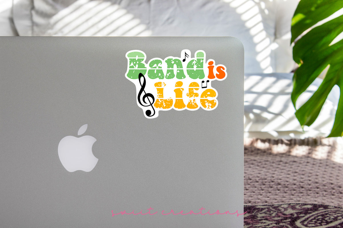 Band Is Life sticker on the lid of a silver laptop
