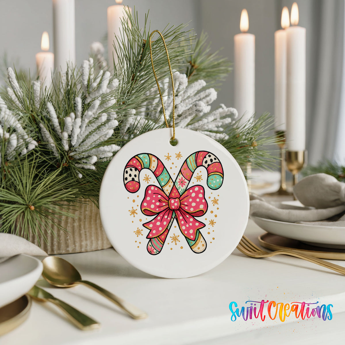 A white ceramic ornament with a colorful candy cane design and a bow, placed on a table with candles and greenery in the background.