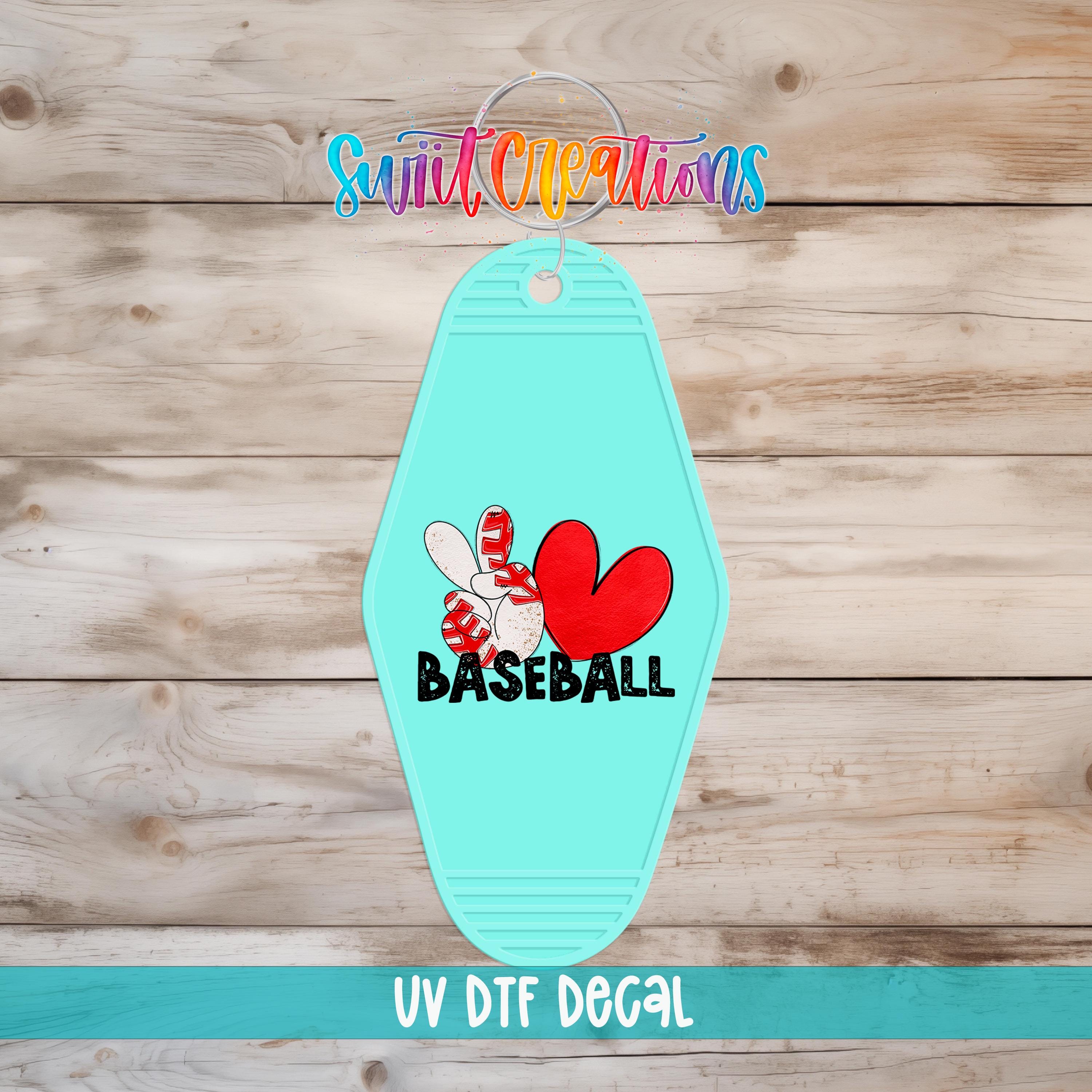 A turquoise keychain with a baseball design and the word "BASEBALL" printed on it, along with a colorful logo and text.