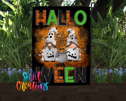 A Halloween-themed garden flag featuring two gnomes wearing ghost costumes and holding pumpkins, with the text "HALLO WELCOME" prominently displayed.