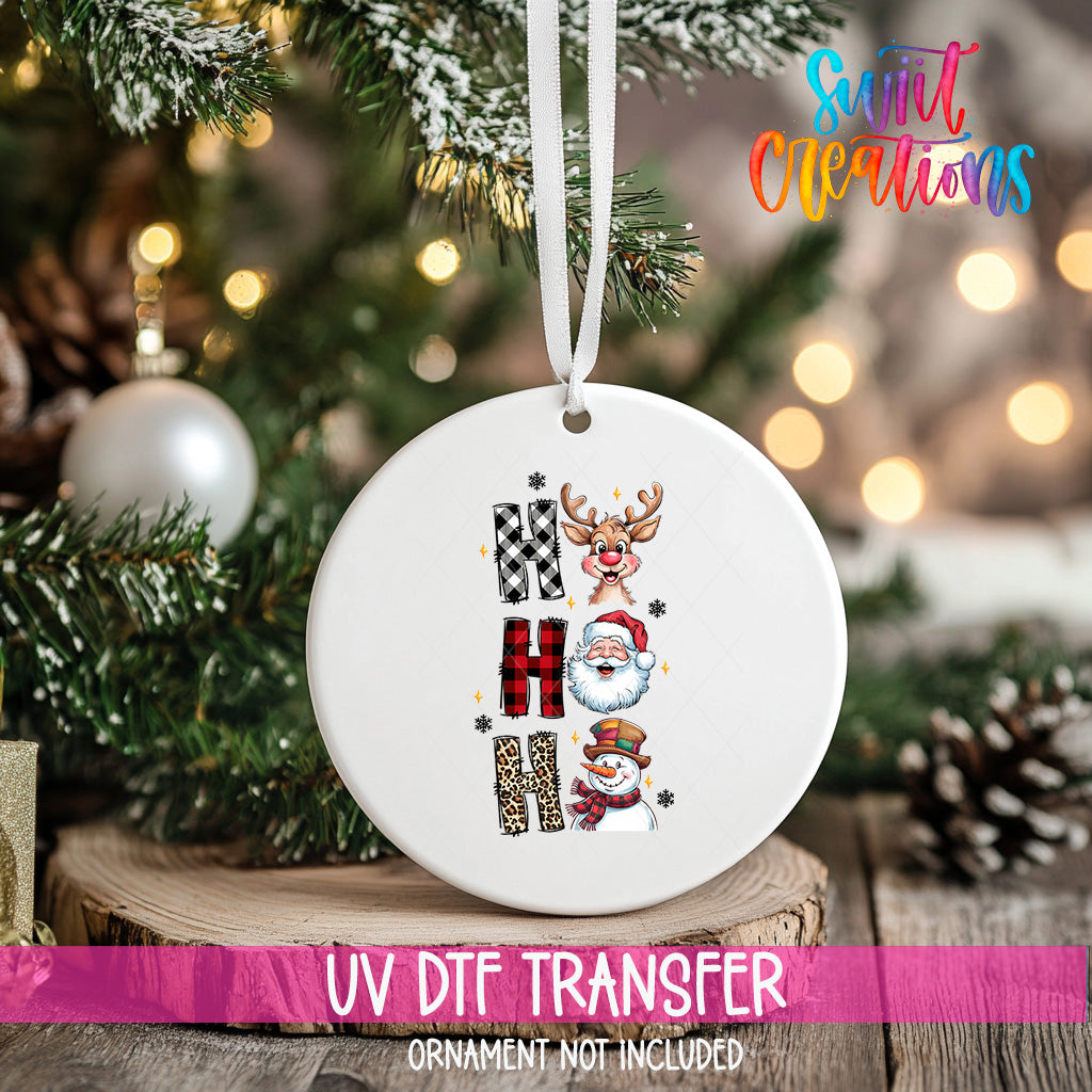 A white ceramic ornament with a Christmas tree and ornaments in the background.