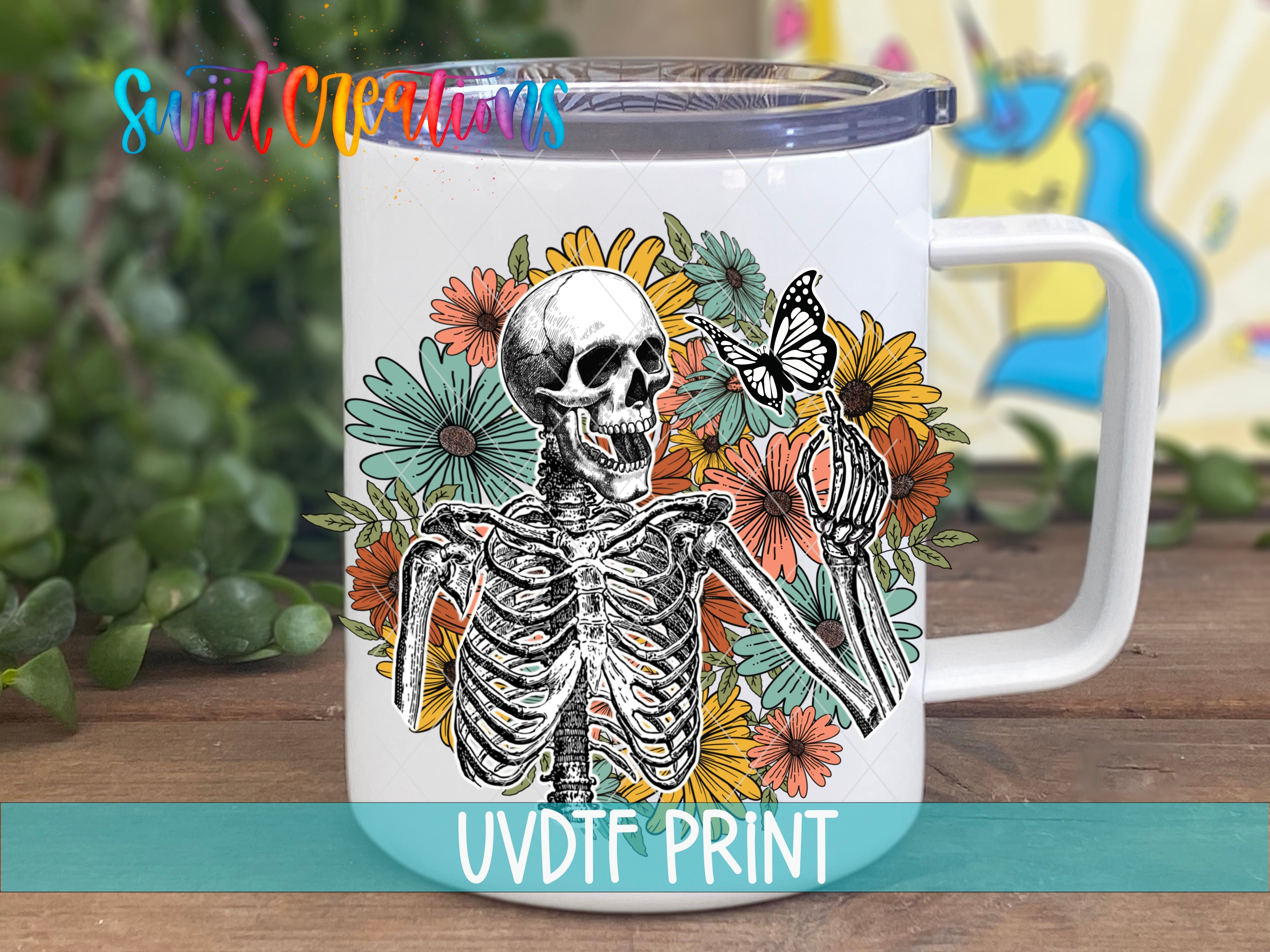a white coffee mug with a skeleton and flowers on it