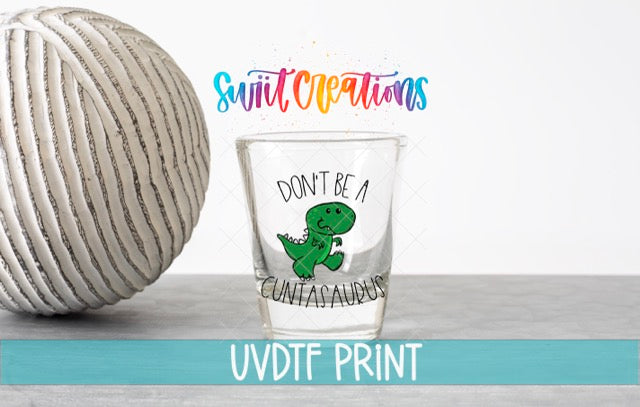 a ball of yarn next to a shot glass