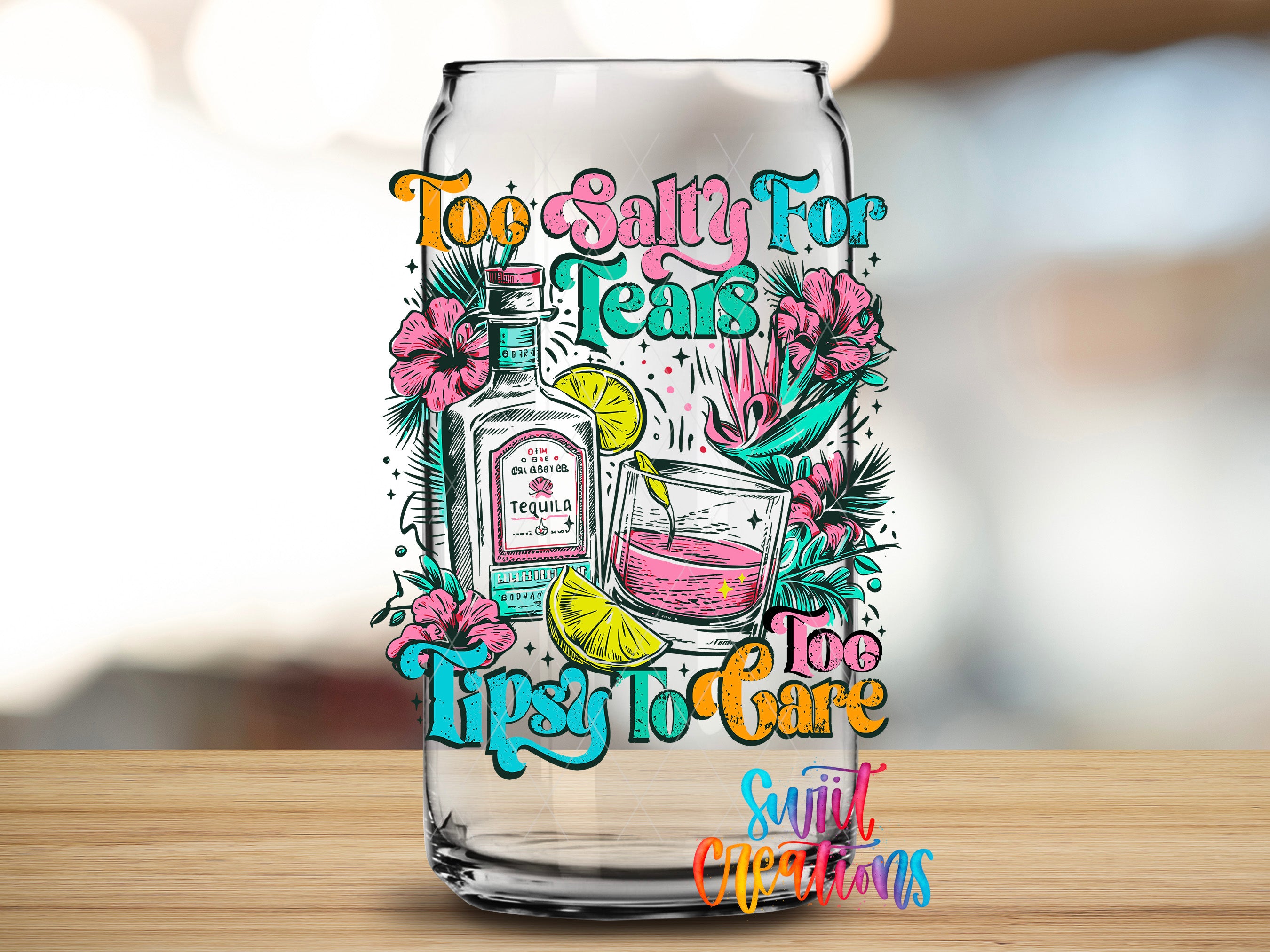 A colorful graphic design featuring a tequila bottle, a glass, and tropical flowers, along with the text "Too Salty for Tears Tipsy to Care" and "Sunlit Occasions" on a glass.