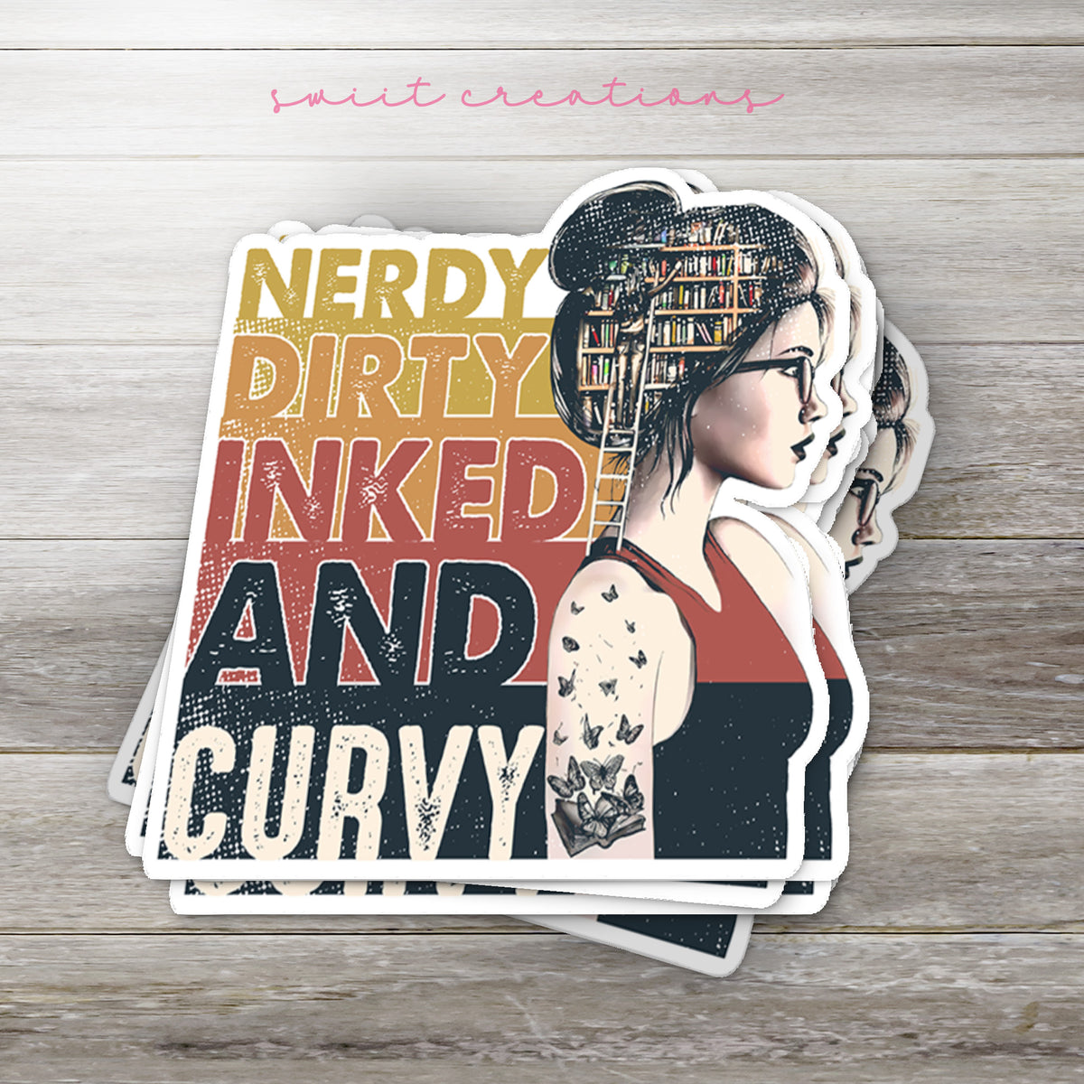 Stack of Nerdy Dirty Inked and Curvy glossy stickers on a gray wood table