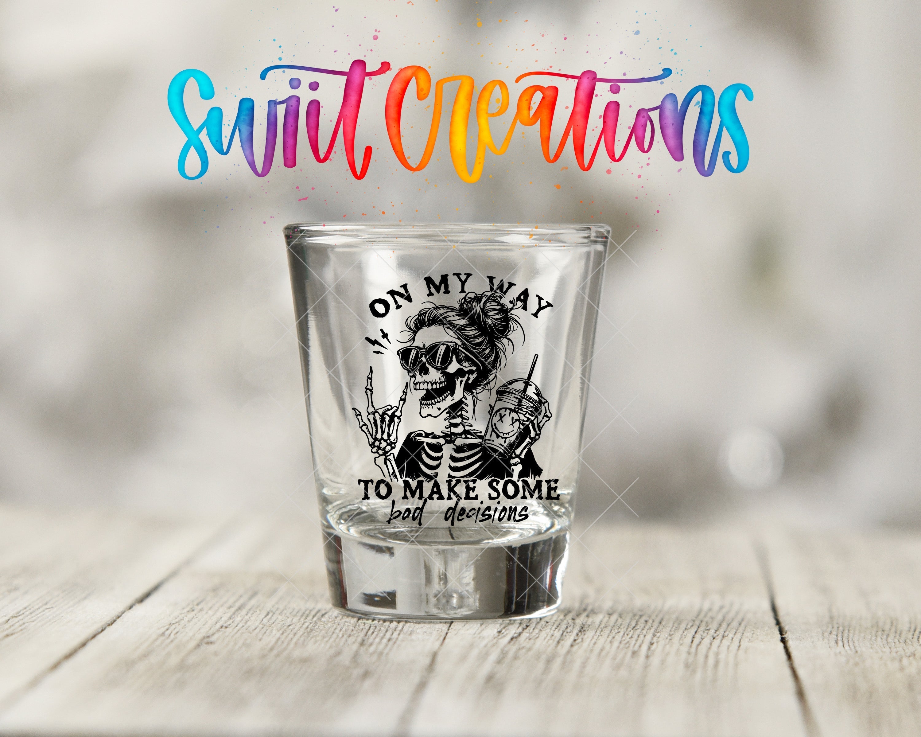 a shot glass sitting on a wooden table