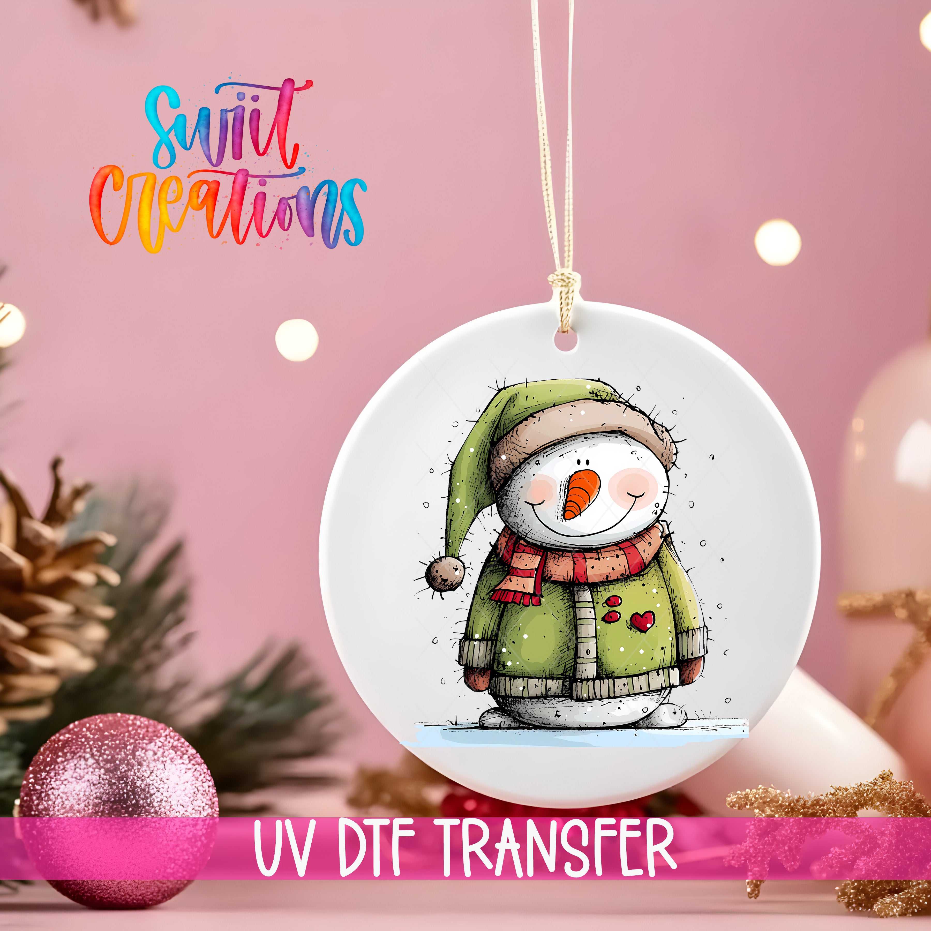 A white ceramic ornament with a snowman design hangs on a pink background, accompanied by a pink glitter ornament and Christmas lights.