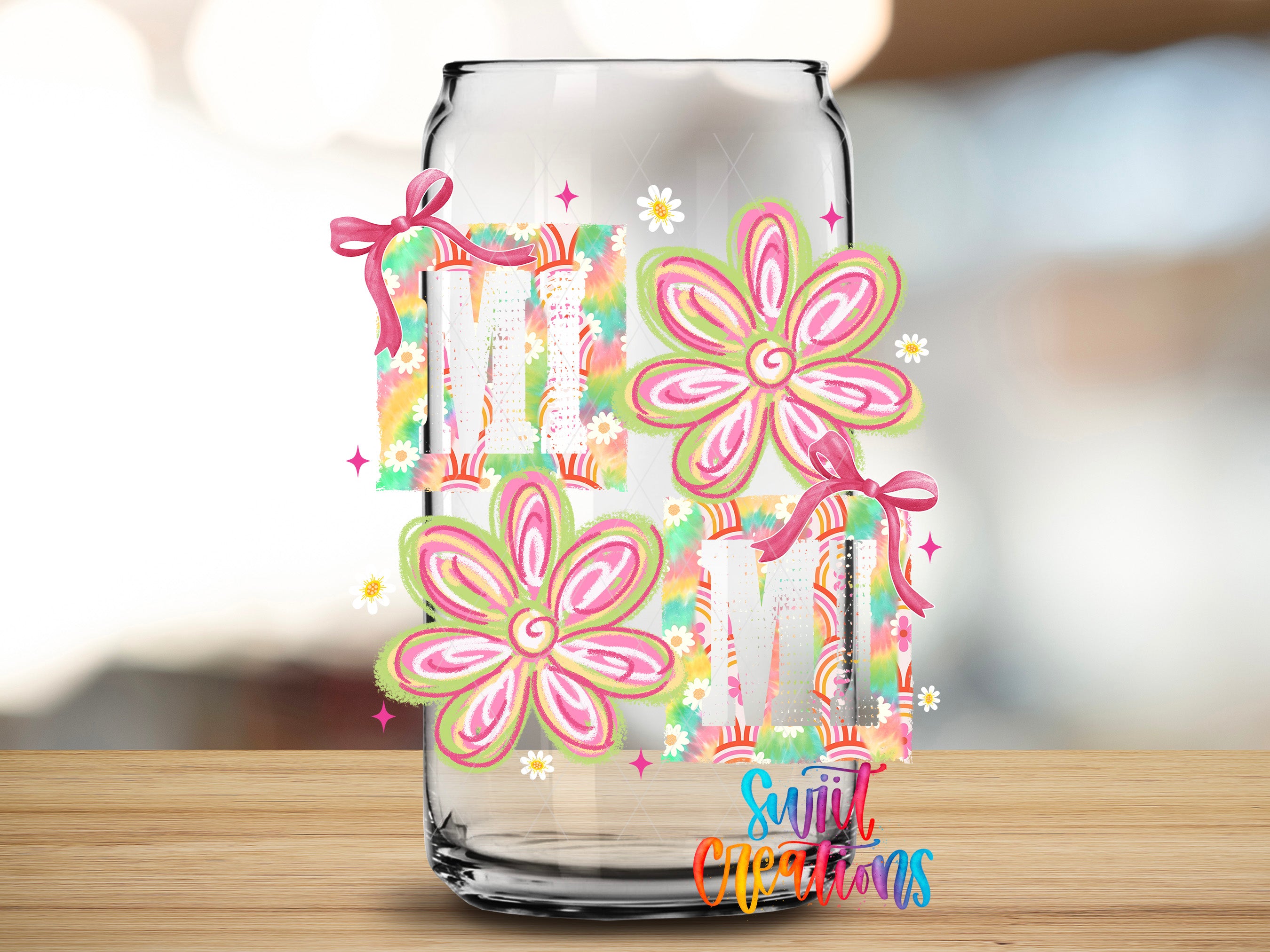 A glass jar with colorful floral designs and the text "MOM" on it, placed on a wooden surface.