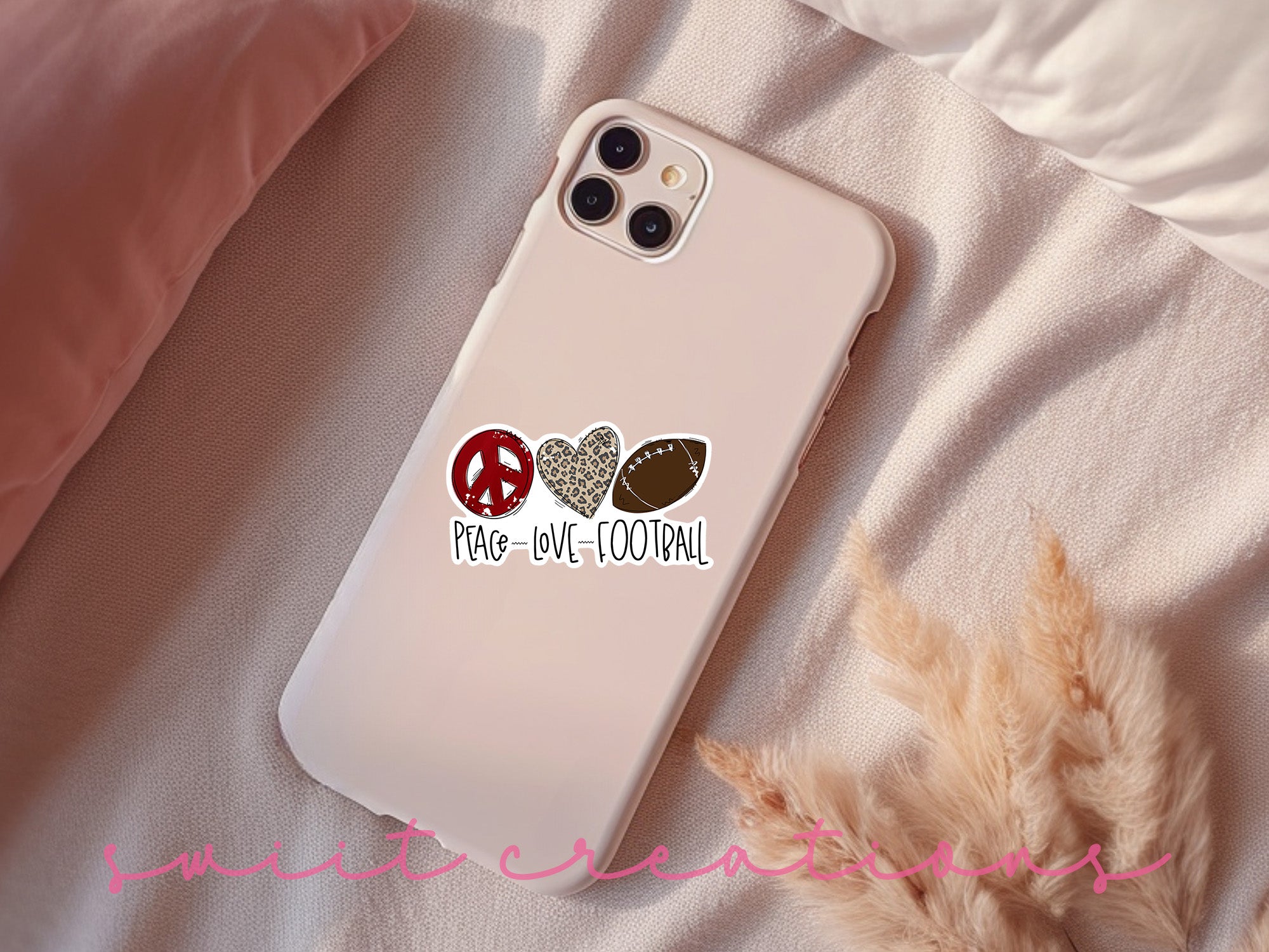 a phone case with a peace, love, and football sticker on it