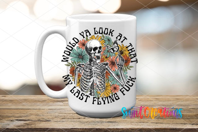 a white coffee mug with a skeleton and flowers on it