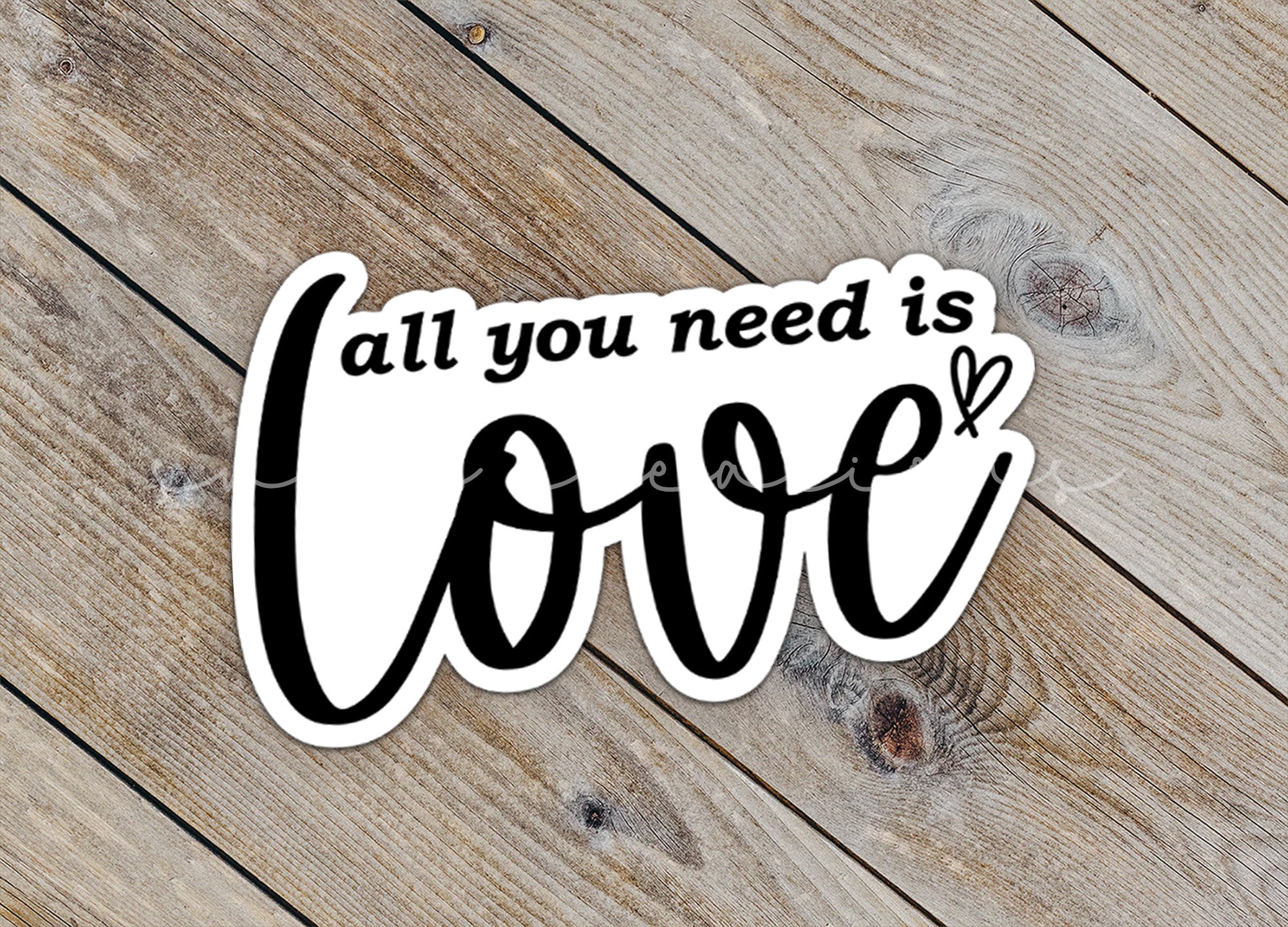 a sticker that says, all you need is love