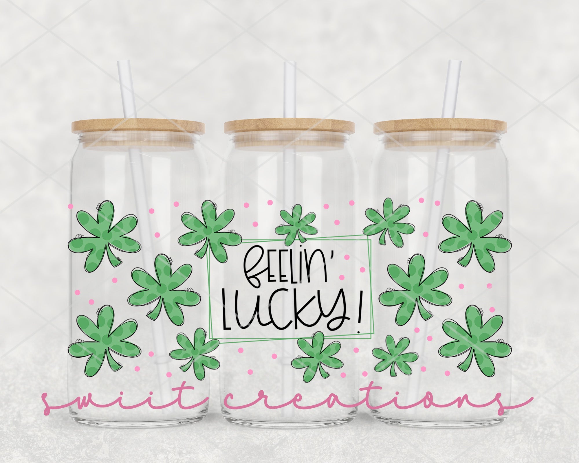three clear tumblers with green shamrocks on them