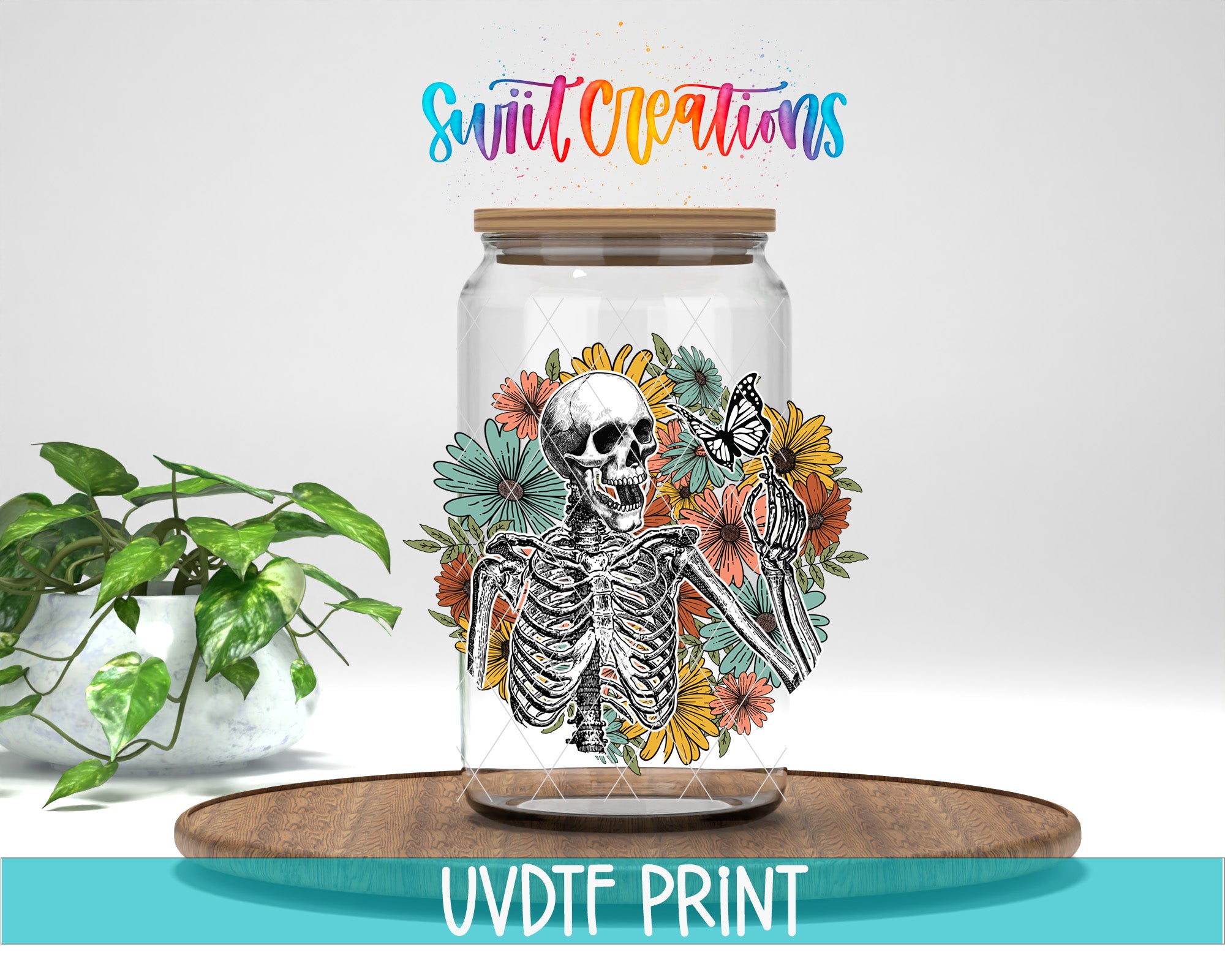 a glass jar with a skeleton and colorful flowers, placed on a wooden surface.