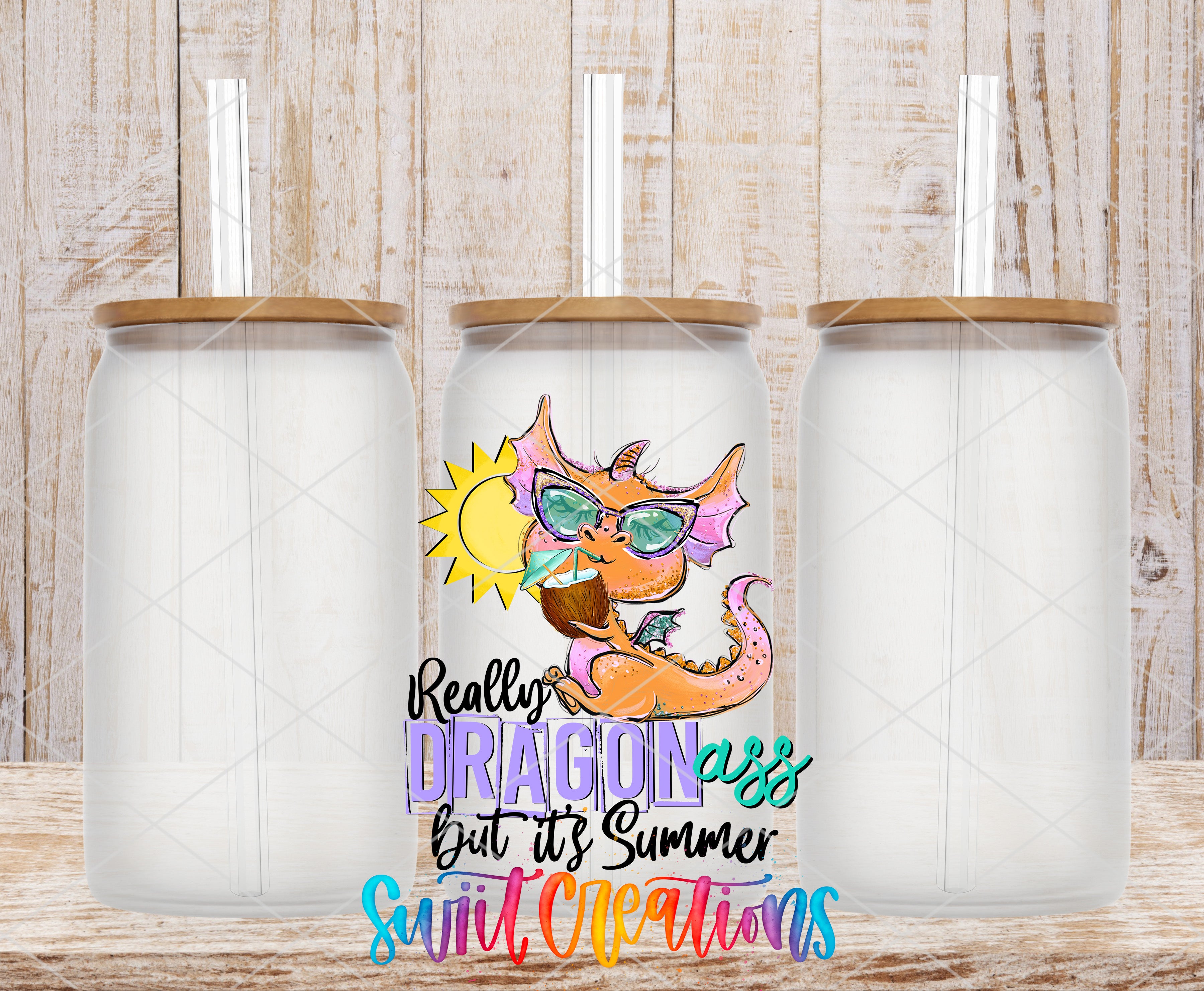 A colorful dragon-themed tumbler with a straw, set against a wooden background.