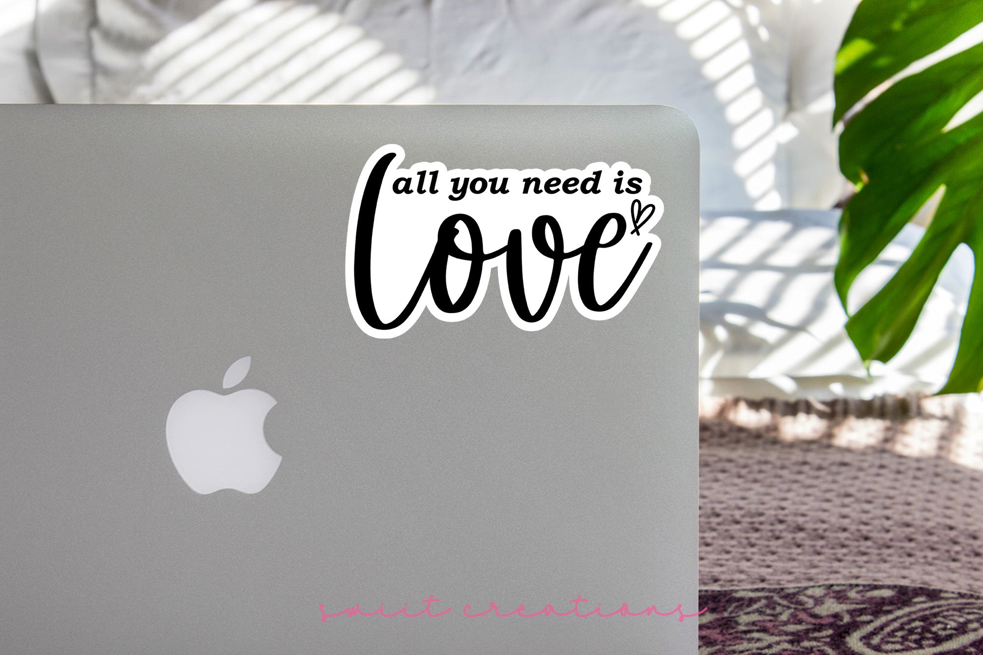 a laptop with a sticker that says all you need is love