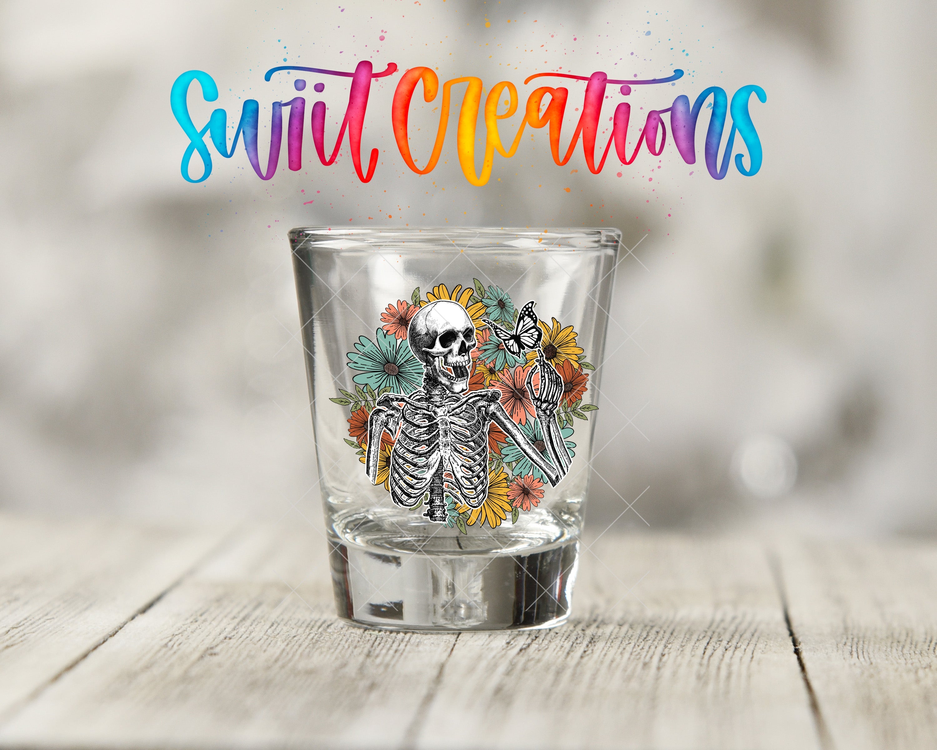 a shot glass with a picture of a skeleton on it