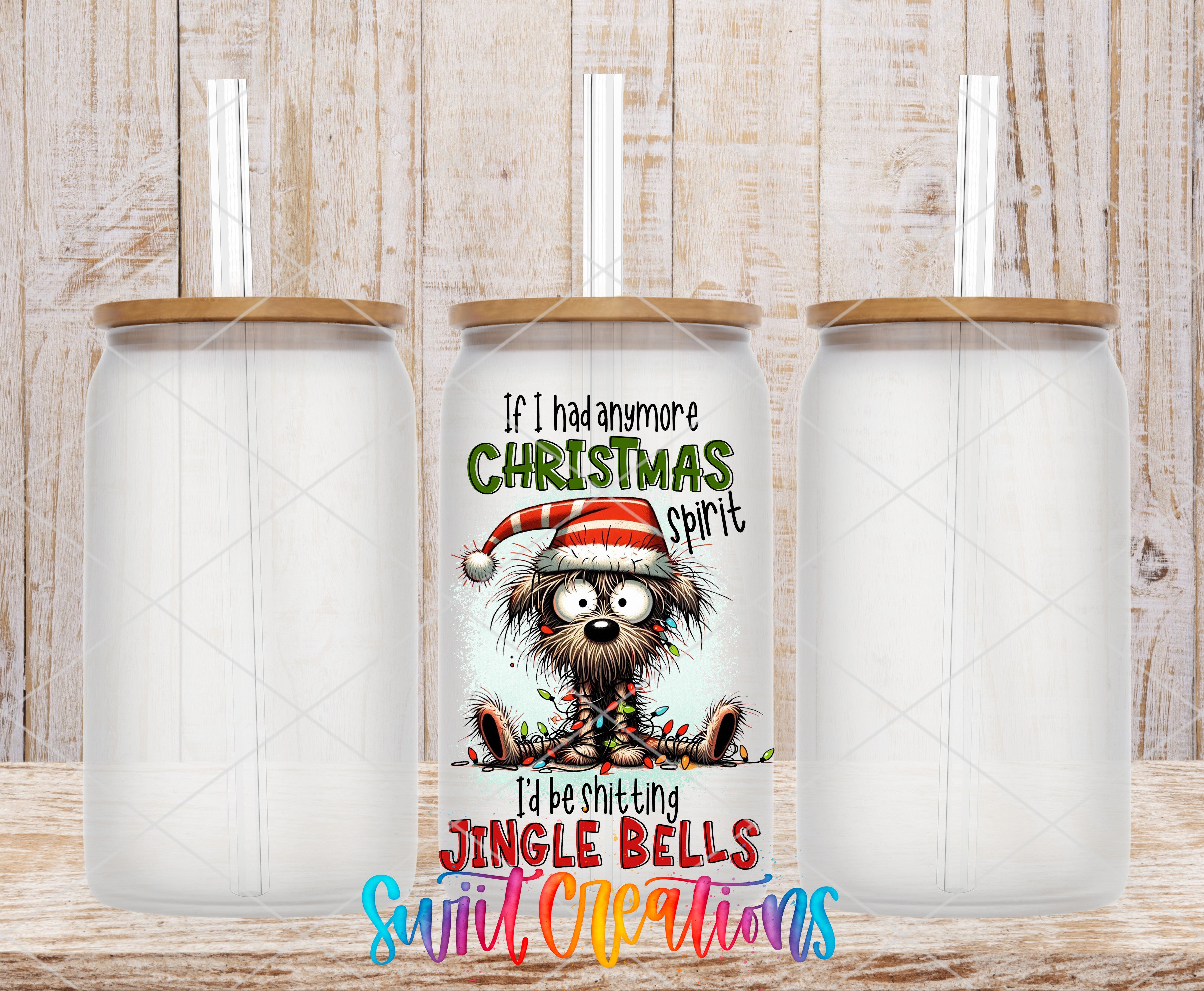 three empty glass tumblers with a colorful Christmas-themed design on the center one.