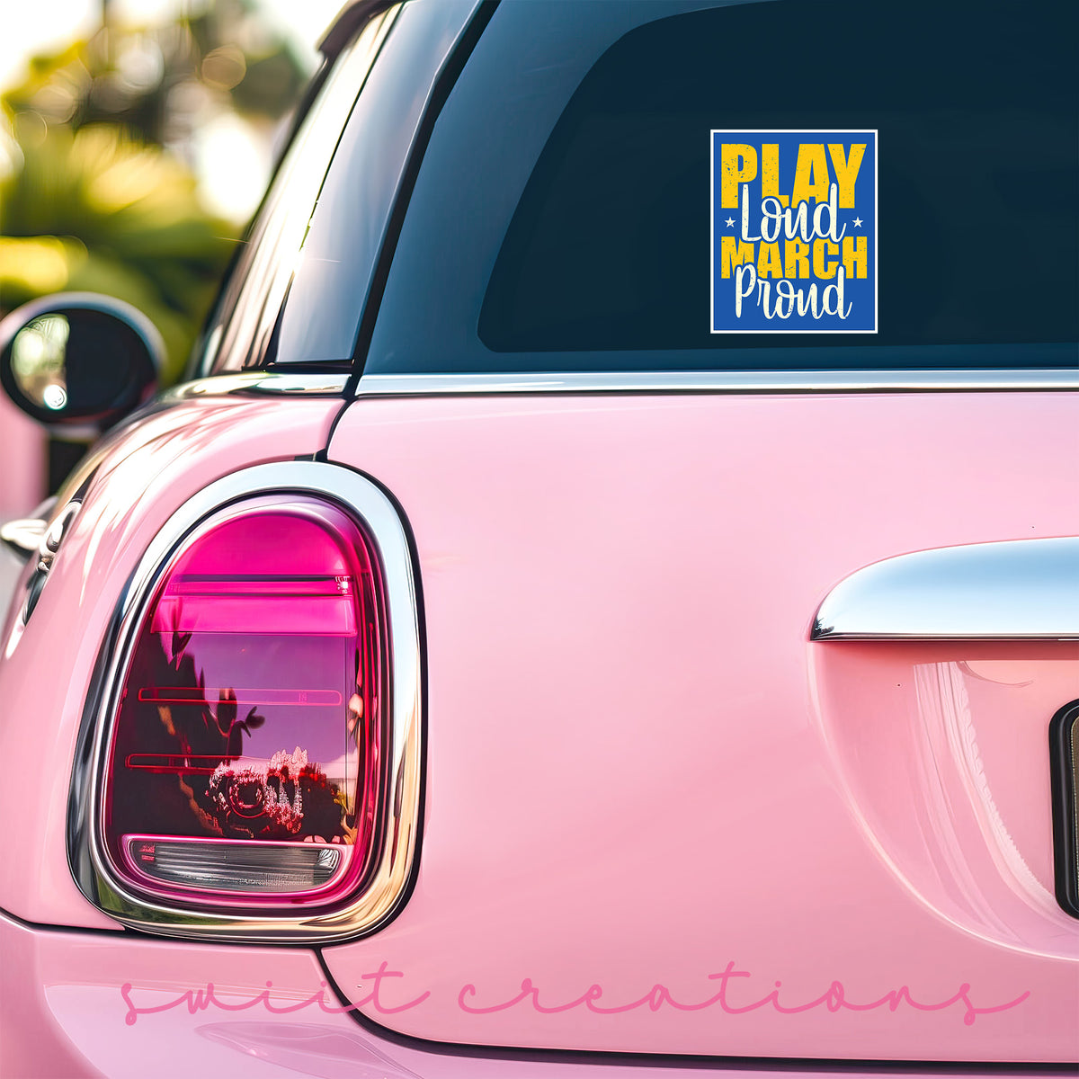 a pink car with a sticker on the back of it