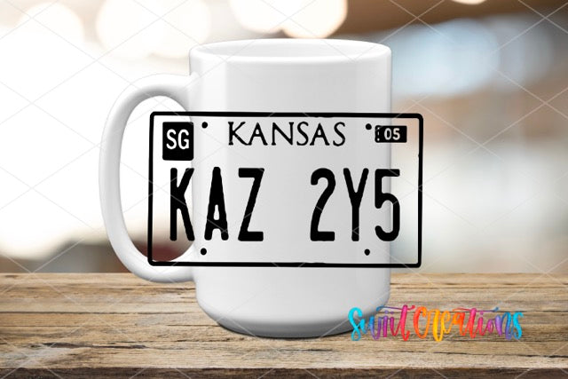 a white coffee mug with a kansas license plate