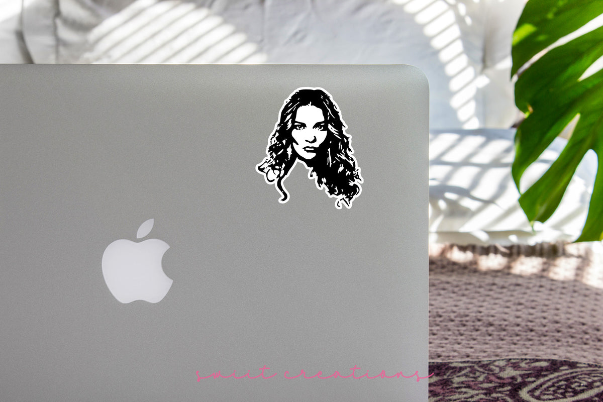 Alexis Portrait sticker on the lid of a silver laptop