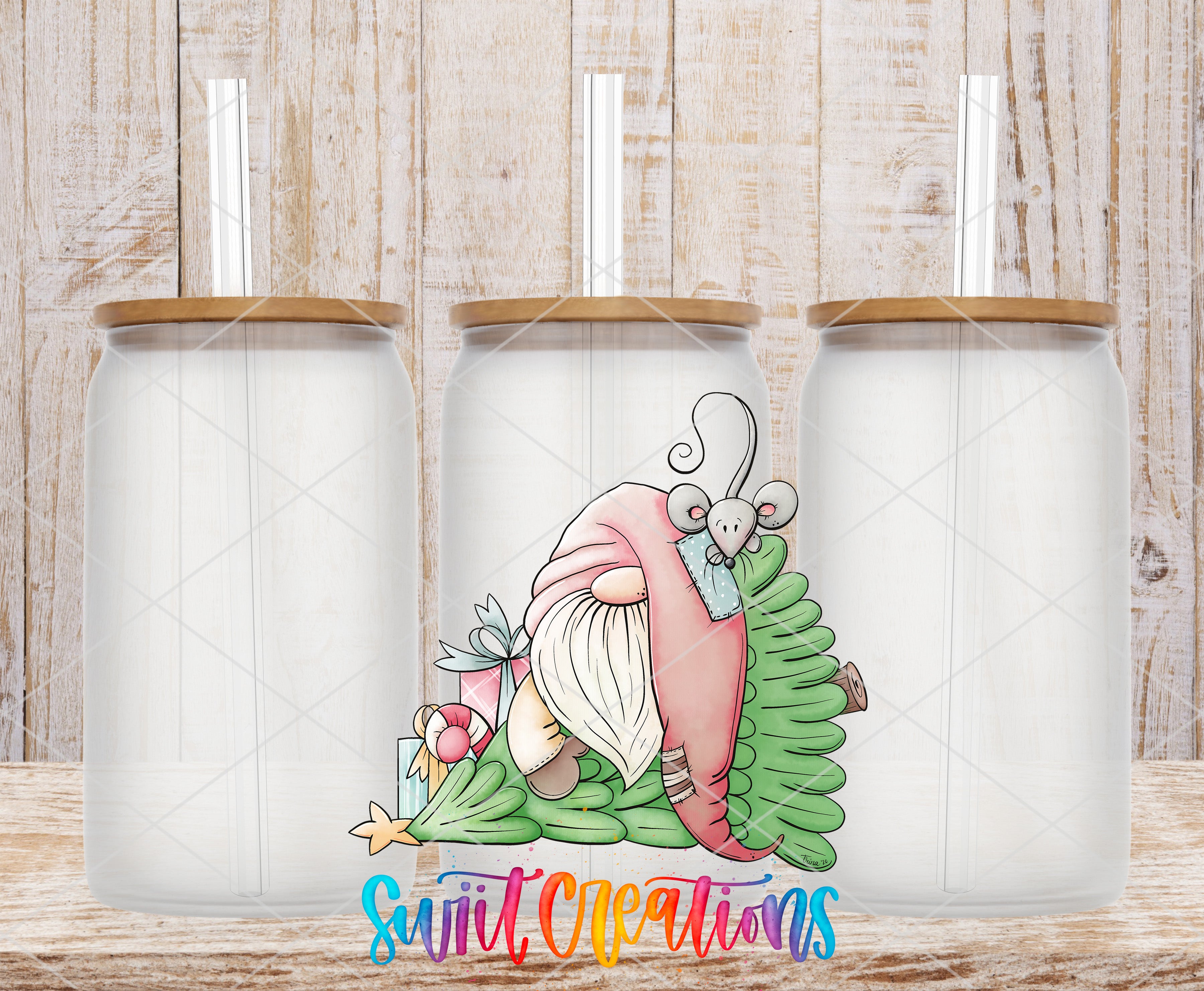 three glass tumblers with a whimsical illustration of a gnome on a Christmas tree.