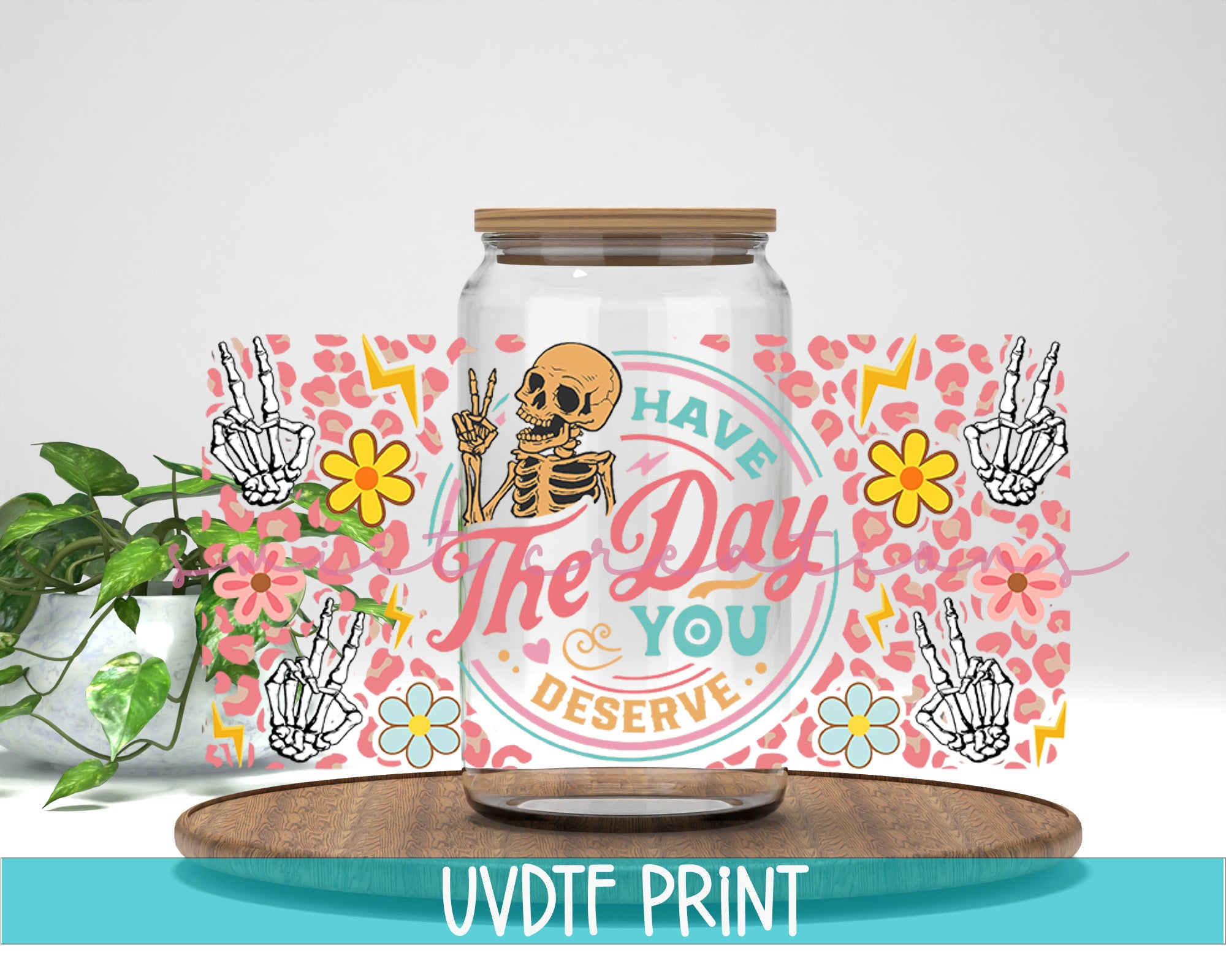 a jar with a skeleton on it next to a plant