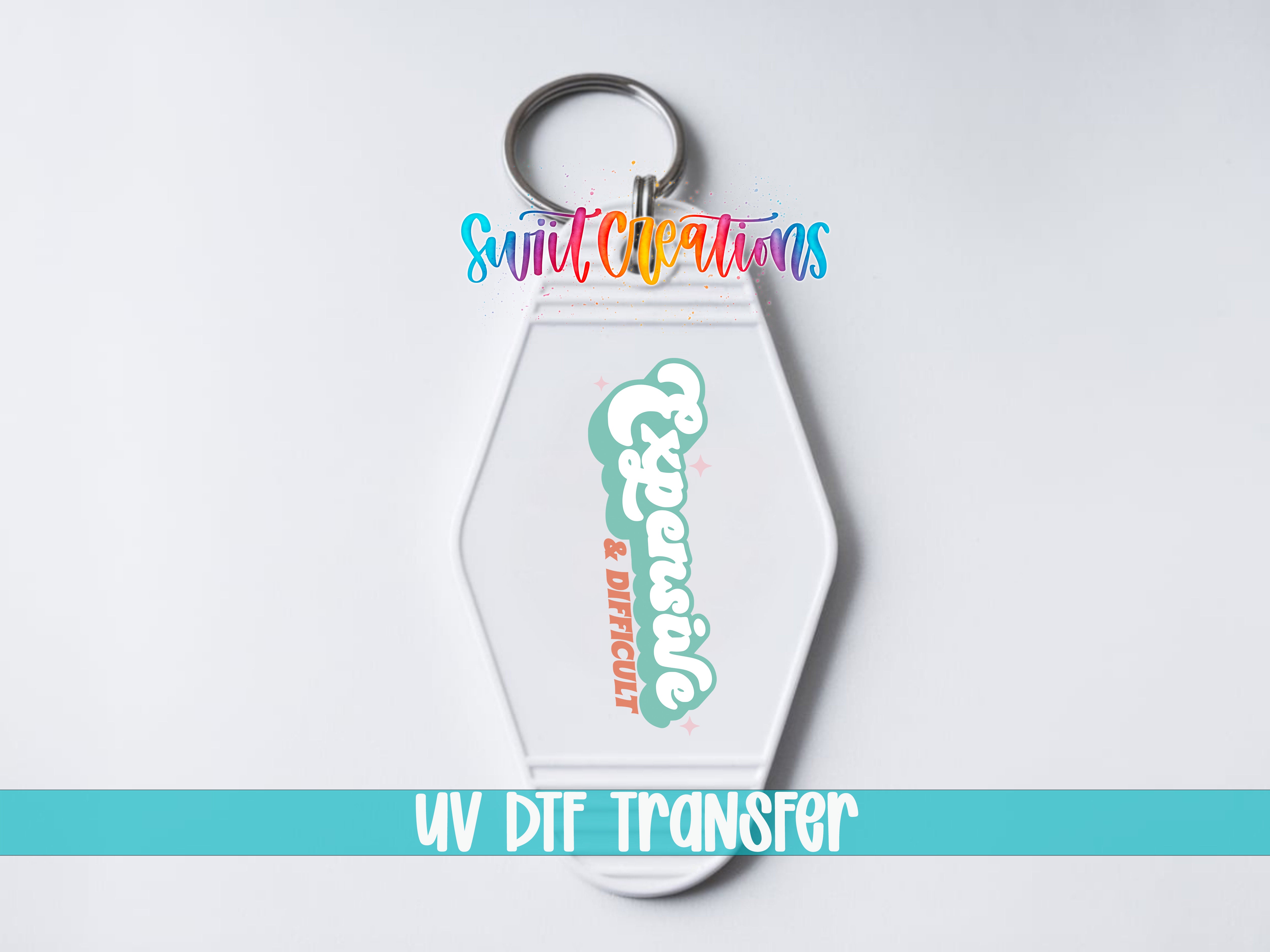 A keychain with a UV DFT (ultraviolet dye-free transfer) logo and text, indicating it is a product for transferring images.