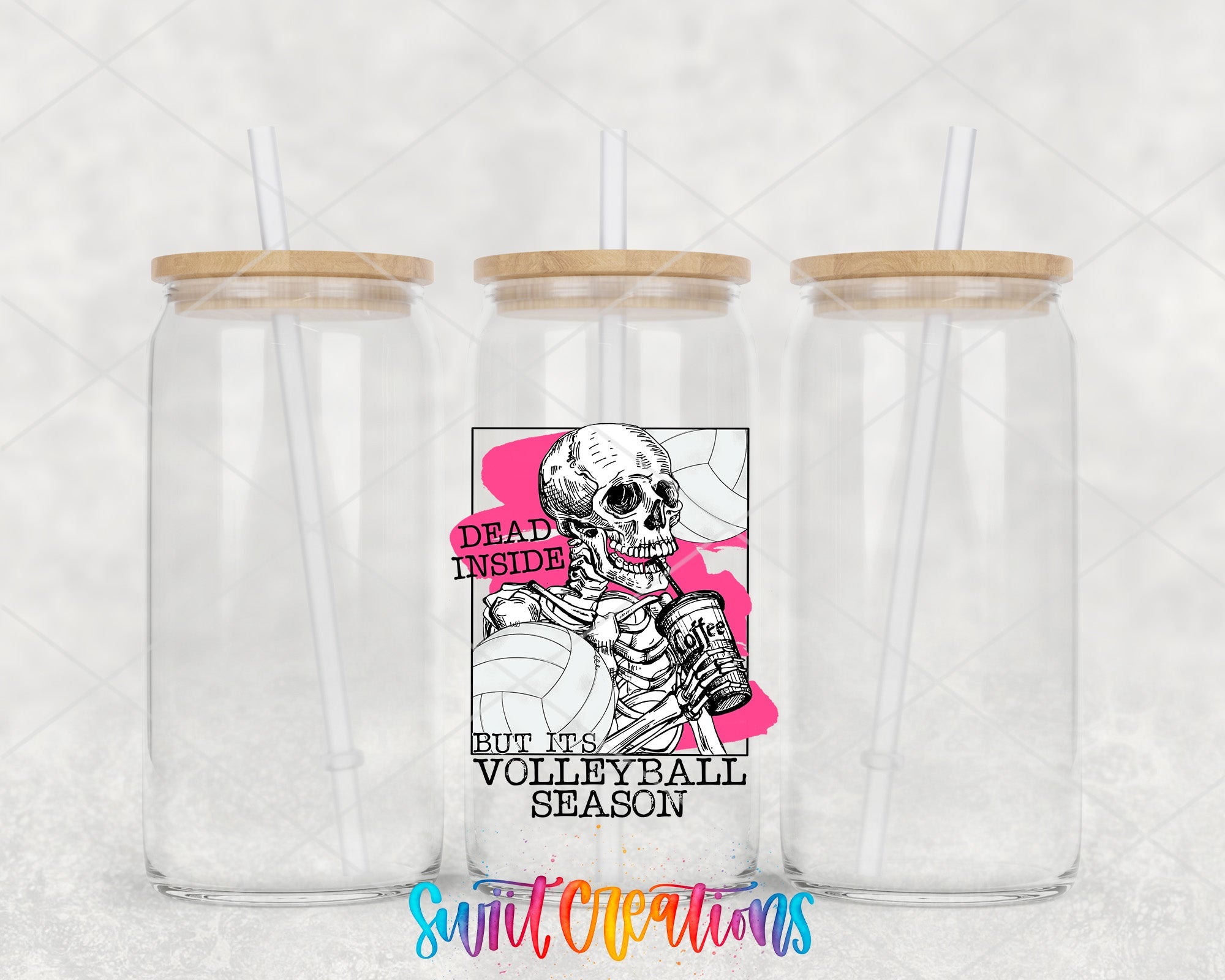 two clear tumblers with wooden lids and a skeleton sticker