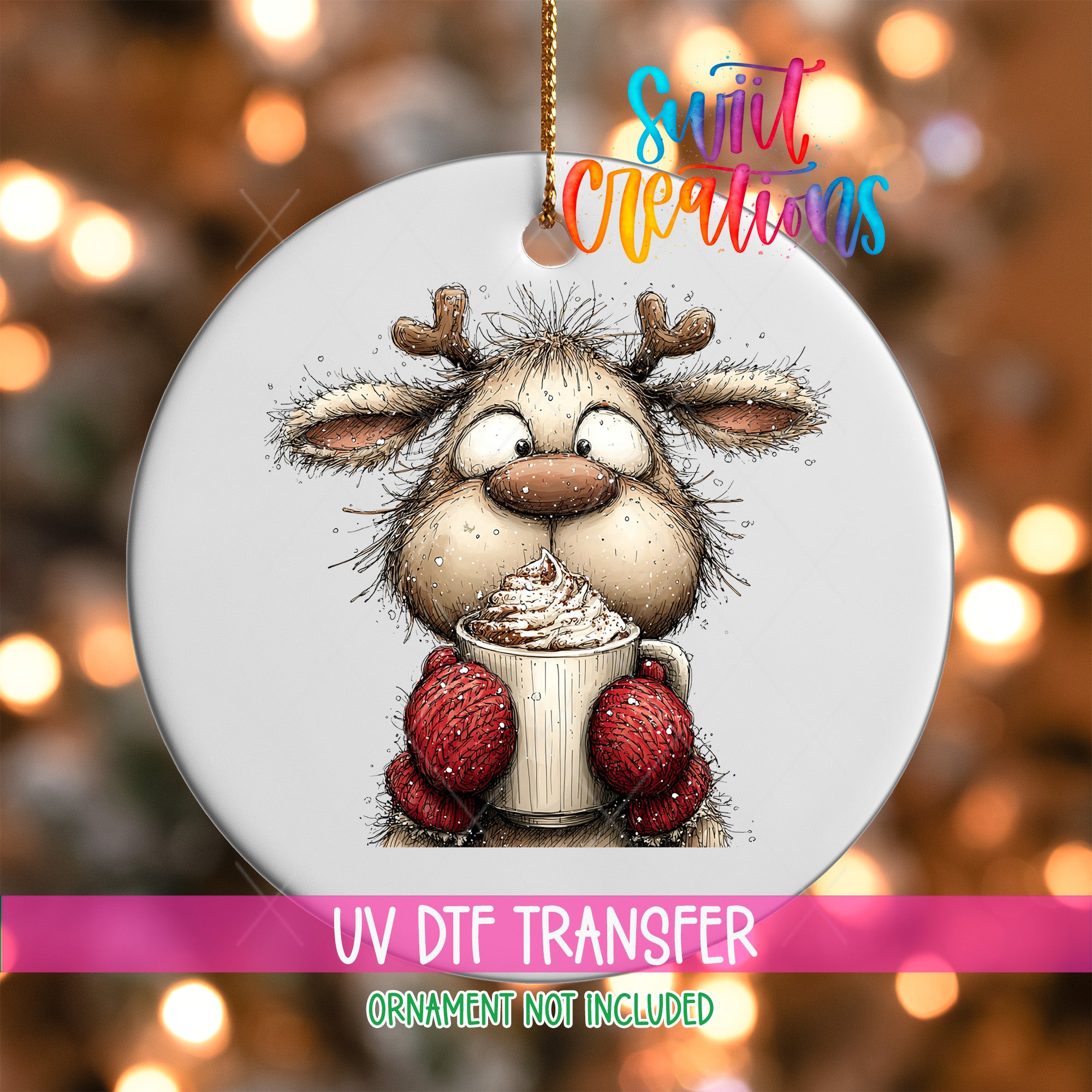 A white ornament with a cartoon reindeer holding a cup of hot chocolate, surrounded by a blurred background of lights.