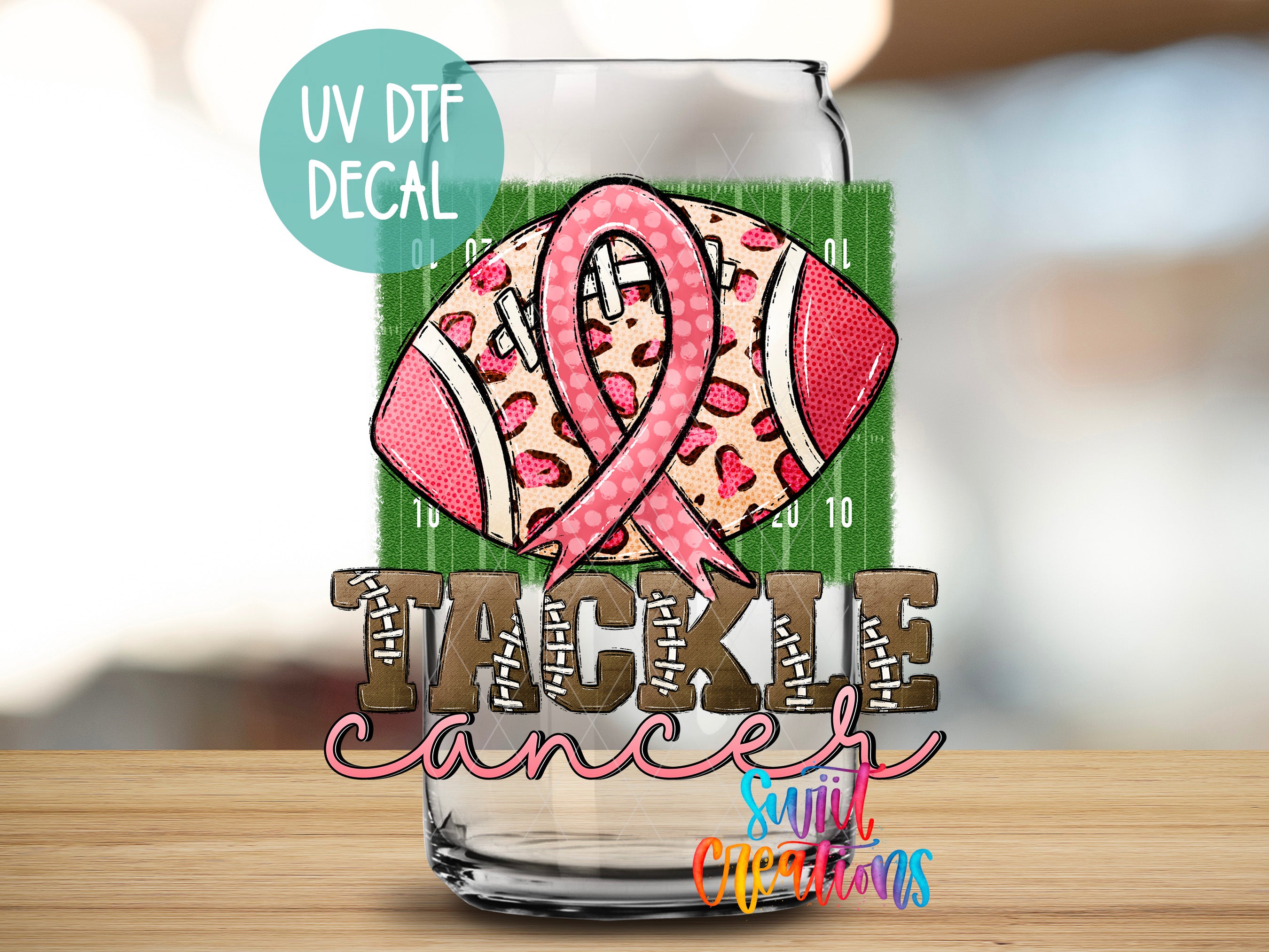 a picture of a glass with a pink ribbon on it